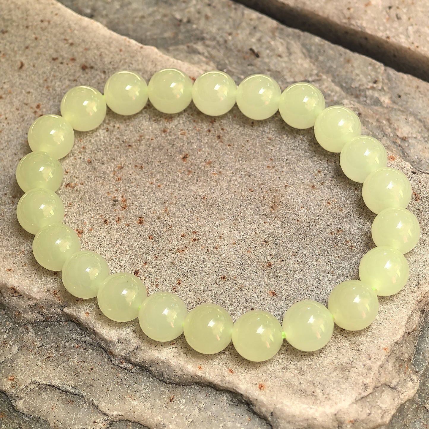 Yellow nephrite elastic bead bracelet showing soft natural tonal variation.
