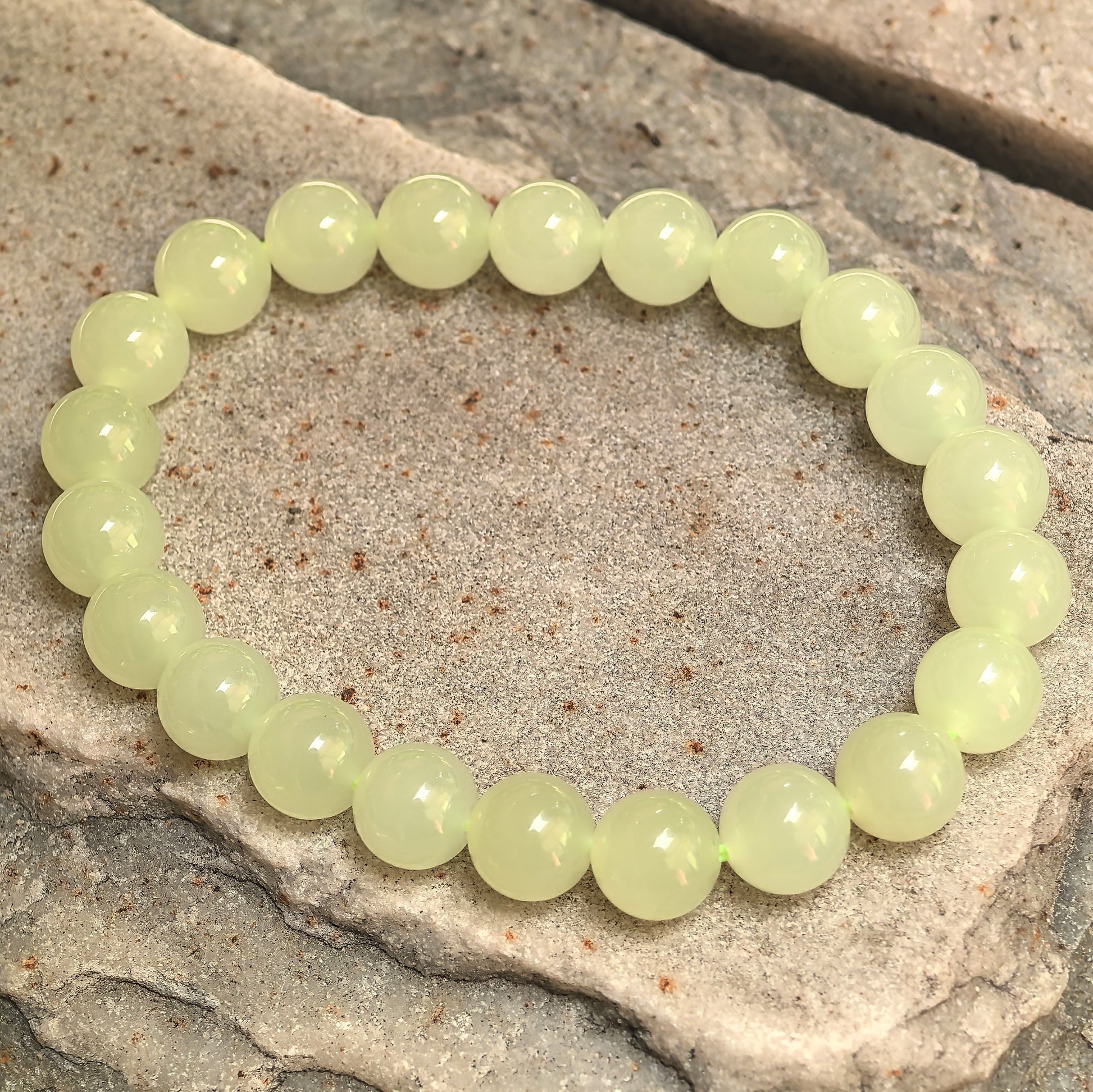 Yellow nephrite elastic bead bracelet showing soft natural tonal variation.