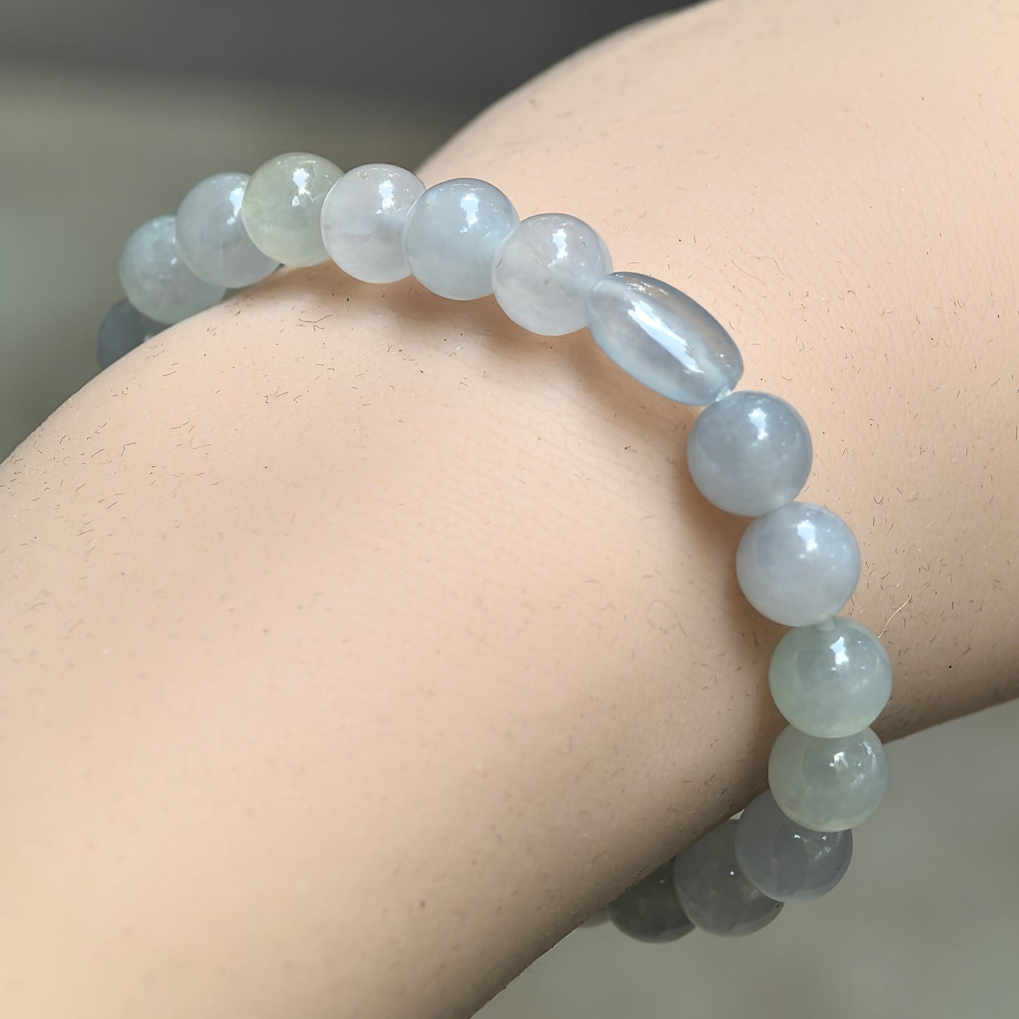 Natural Grade-A glutinous-icy white jadeite bead bracelet worn on wrist.