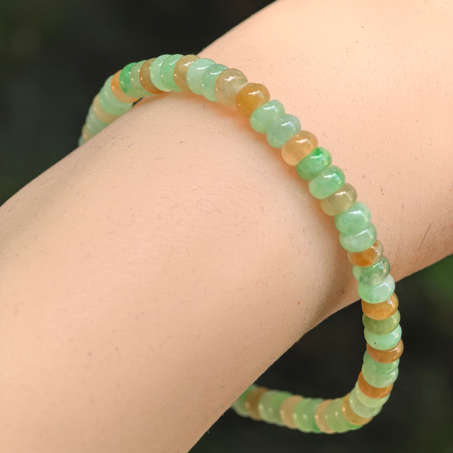 Natural Grade-A glutinous-icy multicolor jadeite abacus bead bracelet worn on wrist.