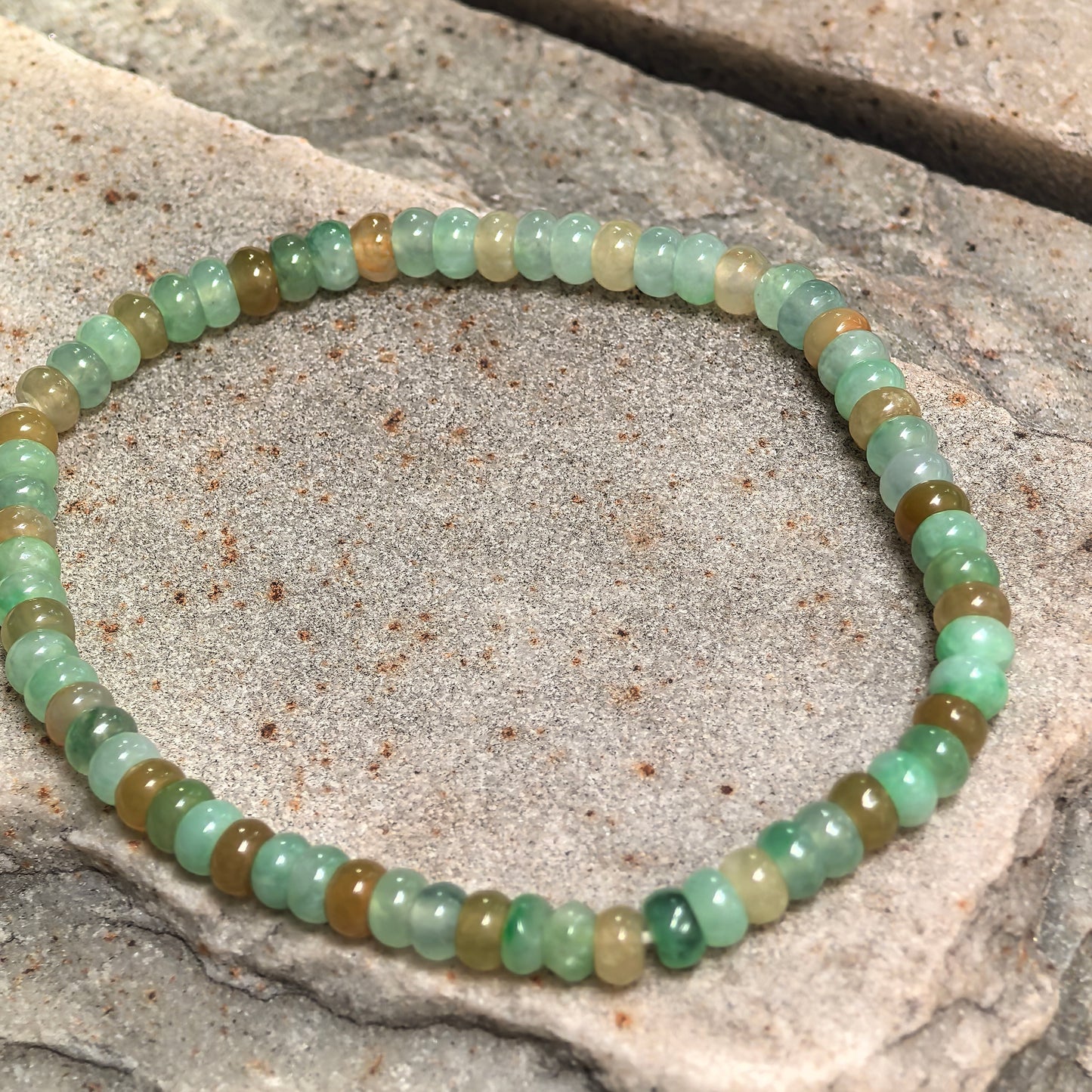 Glutinous-icy multicolor jadeite bead bracelet showing soft translucency and glossy polish.