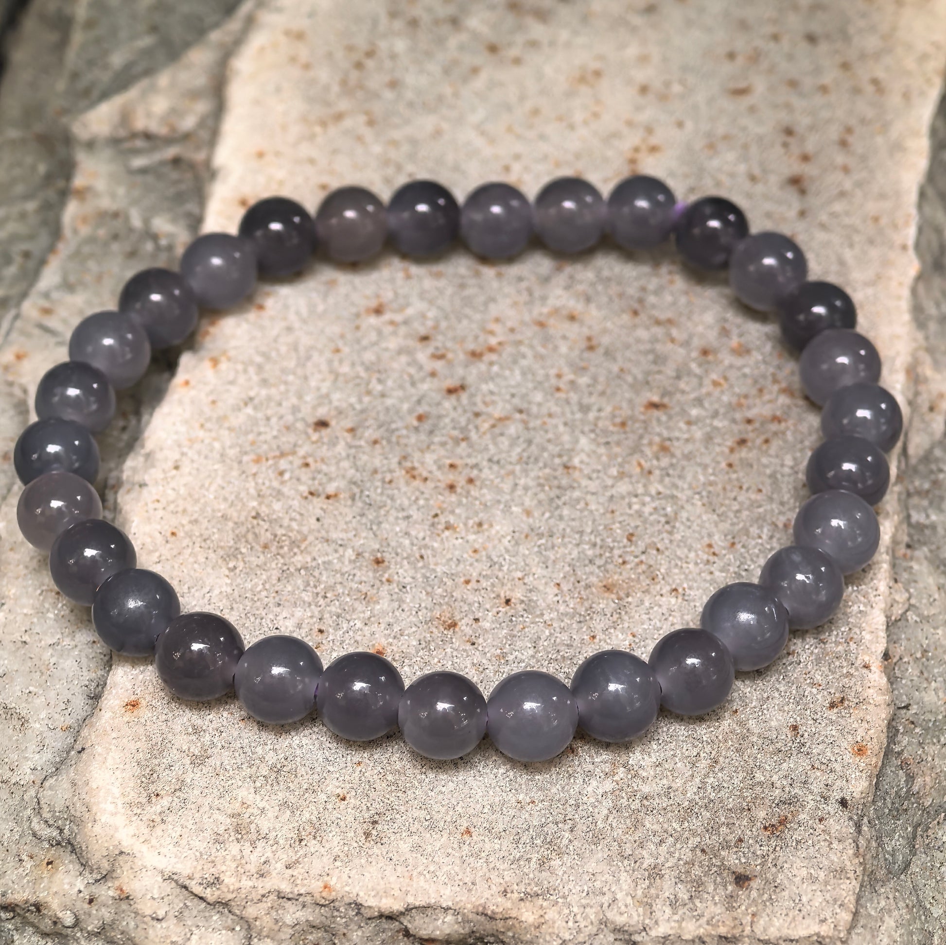 Natural Hetian jade elastic bead bracelet with soft polished luster.