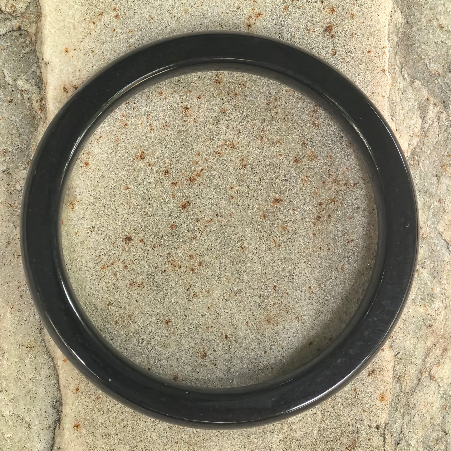 Top view of natural Hetian jade square-profile bangle showing circular ring shape.