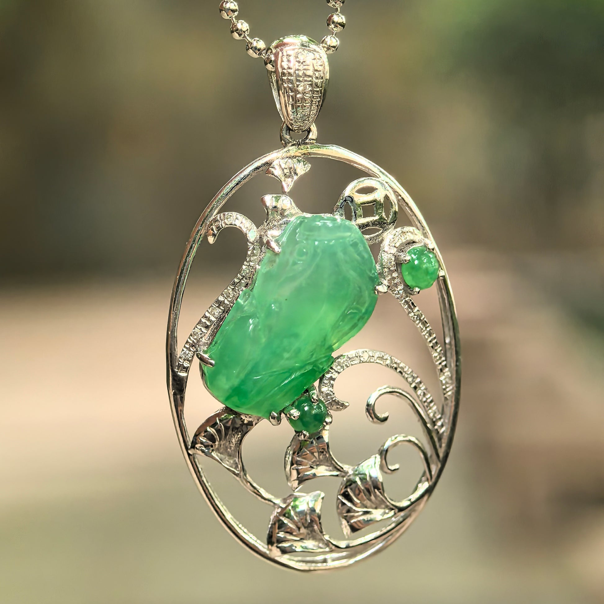 Natural Grade-A icy translucent green jade Pixiu pendant in 18K gold openwork frame showing vivid green tone and smooth translucent texture.
