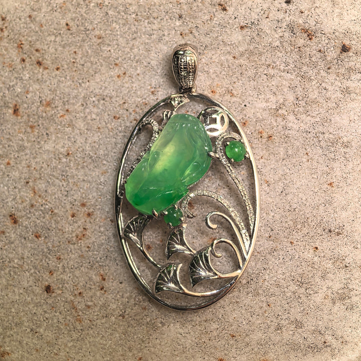Close-up of Pixiu carving in icy green jadeite showing fine detail, gel-like luster, and natural internal structure.
