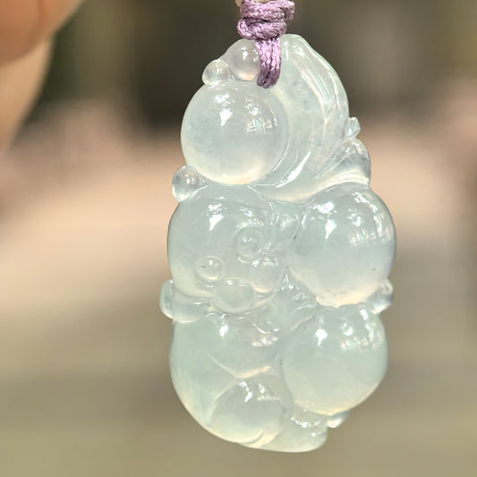 Natural Grade-A glutinous icy pale green monkey jadeite pendant hanging on cord.