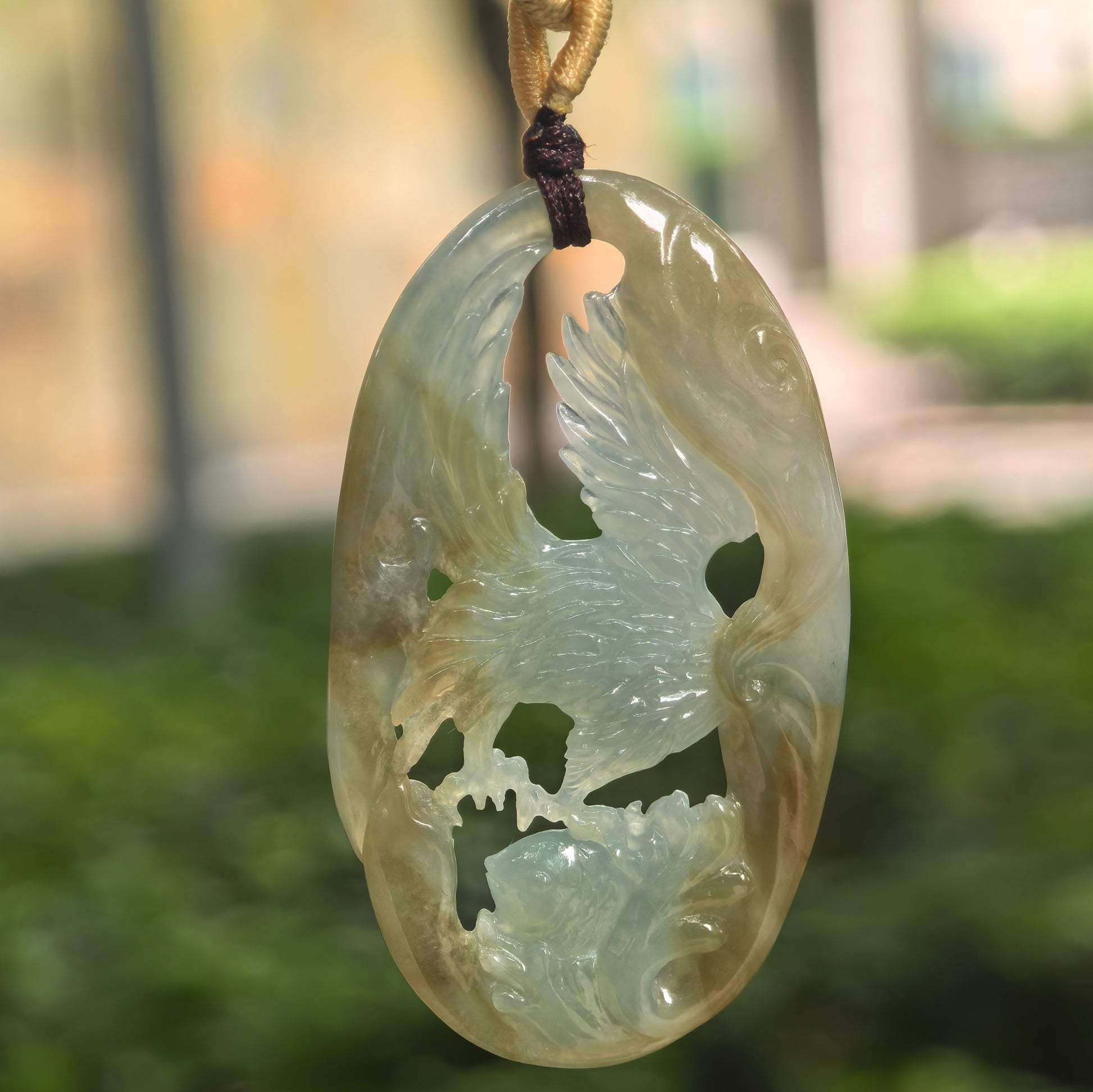 Natural Grade-A glutinous yellow and green jadeite eagle pendant hanging on cord.