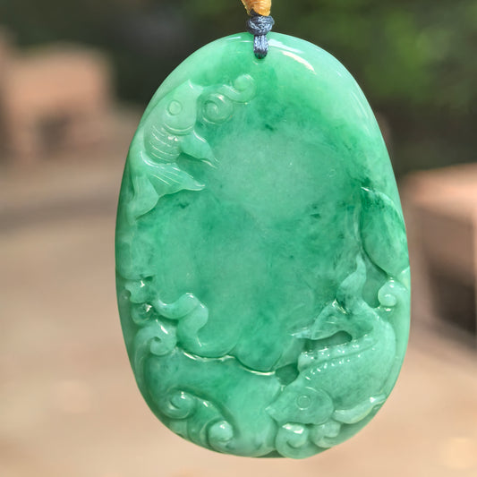 Natural Grade-A glutinous green fish plaque jadeite pendant hanging on cord with vivid green color.