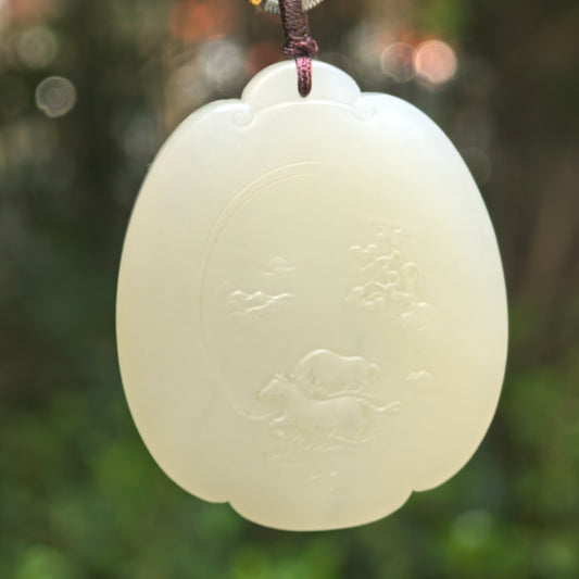 Natural Hetian jade greenish-white horse plaque pendant hanging against a soft green background.