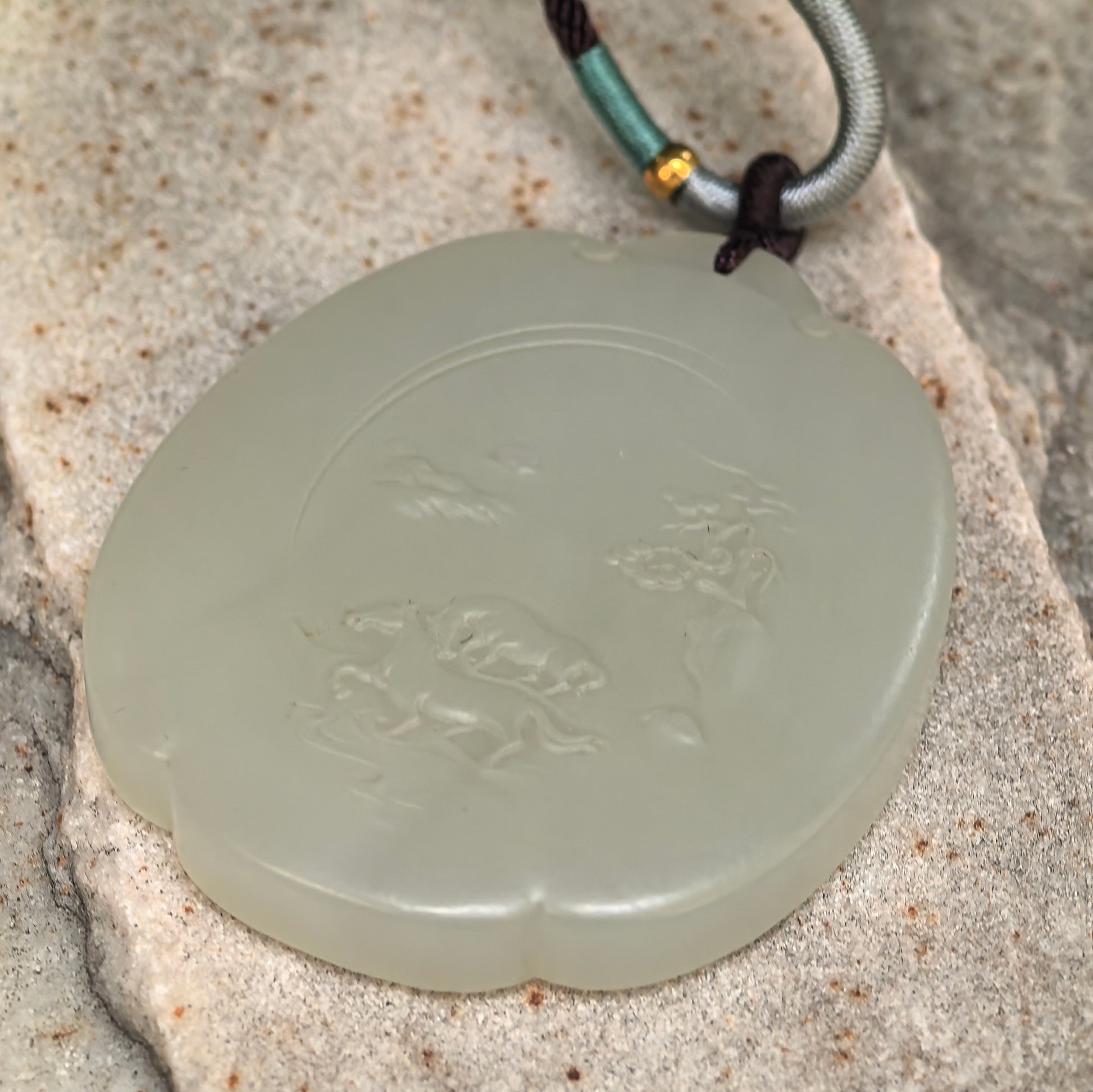 Side view of large Hetian jade plaque pendant showing 8 mm thickness and smooth polished edge.
