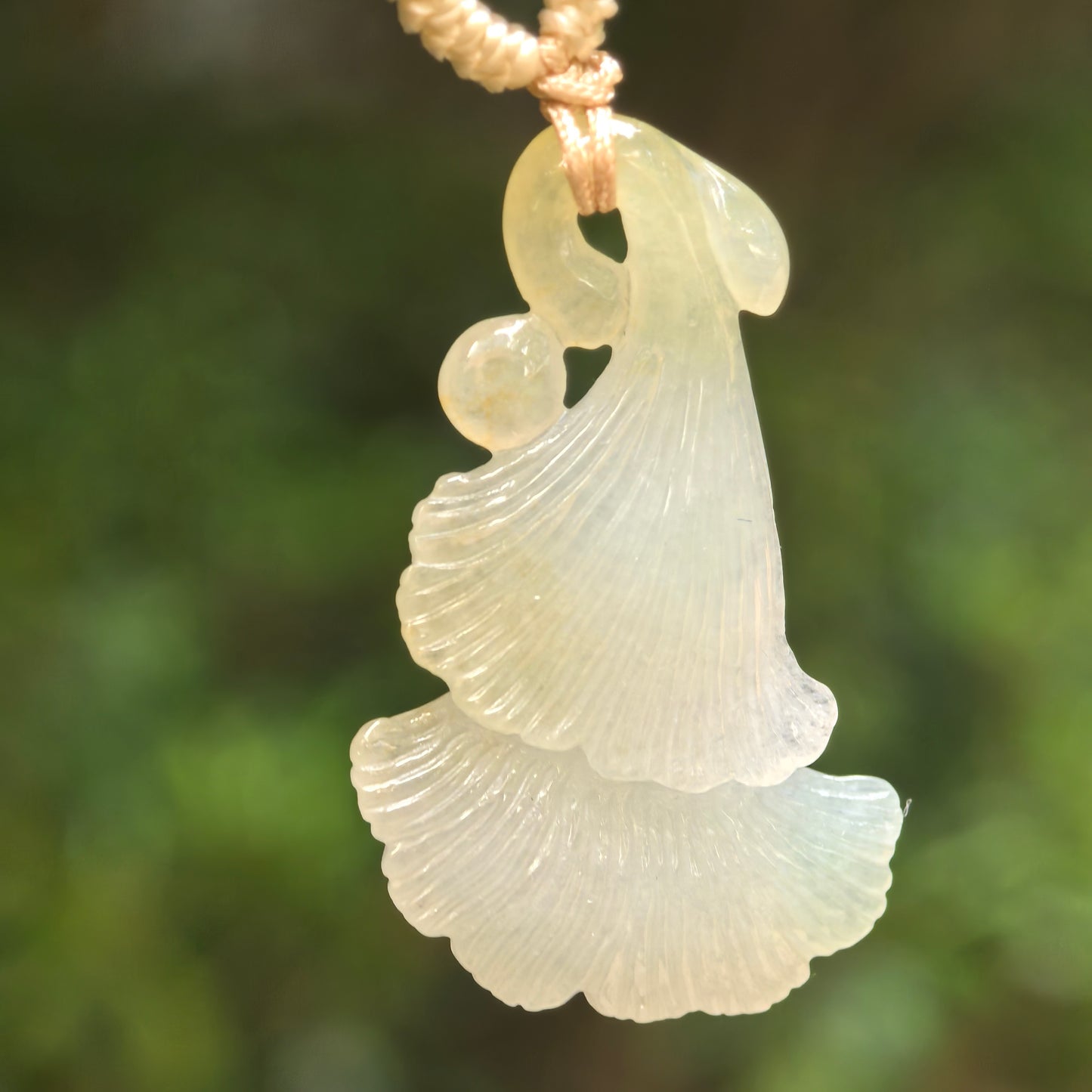 Natural Grade-A icy glutinous light green and yellow ginkgo leaf jadeite pendant hanging on cord.