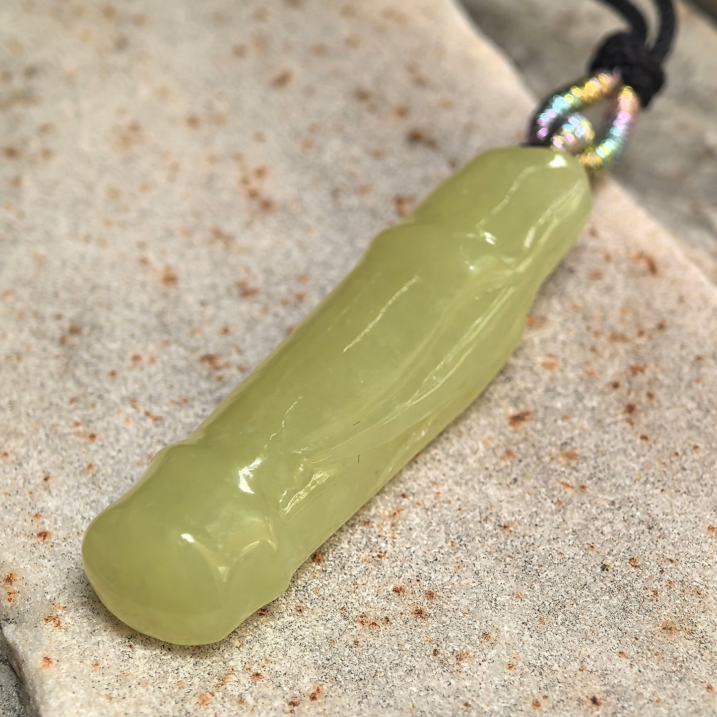 Side view of natural Hetian jade bamboo pendant showing 9 mm thickness and rounded carving.