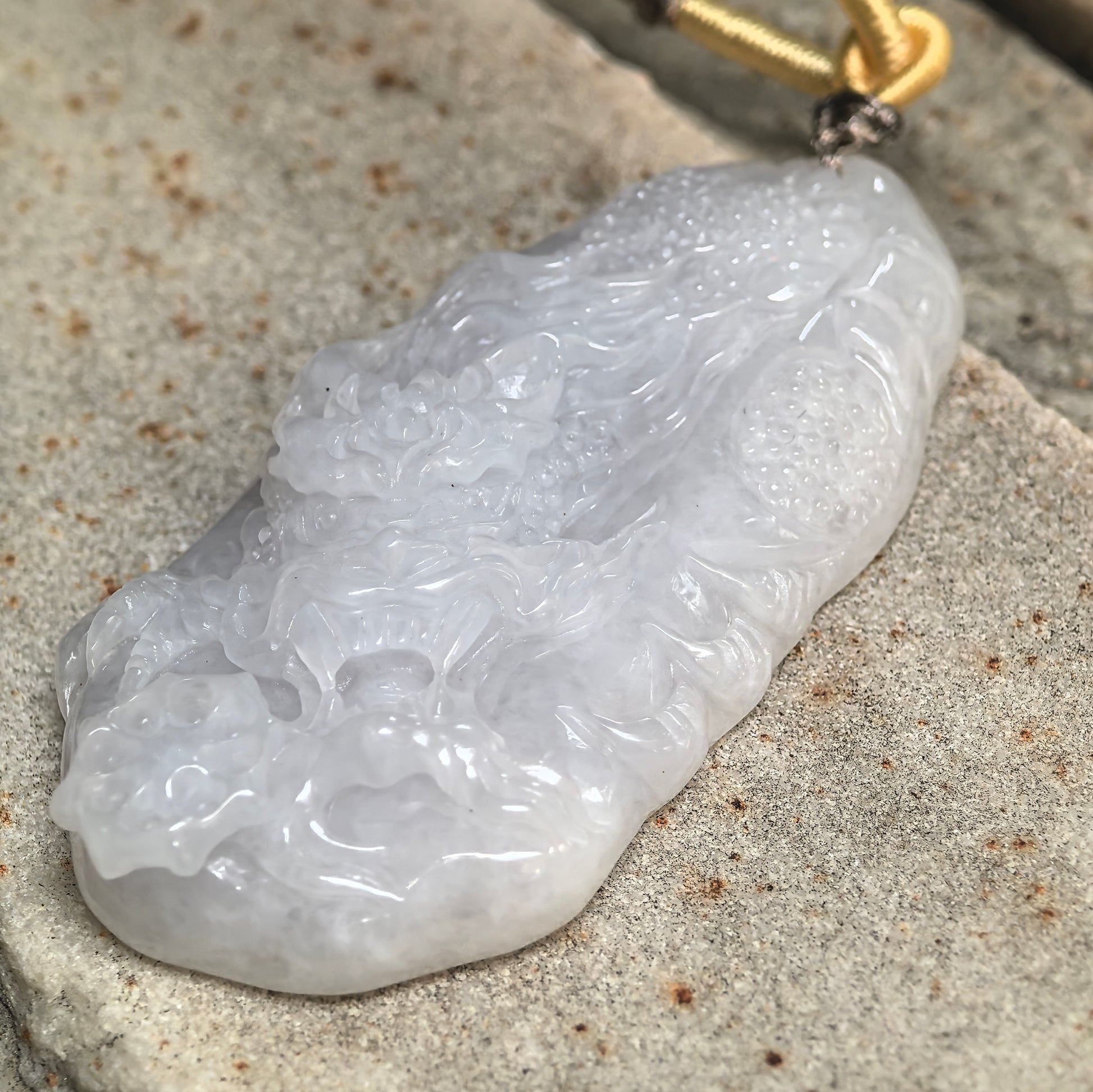 Side view of white jadeite dragon pendant showing approximately 10.5 mm thickness.
