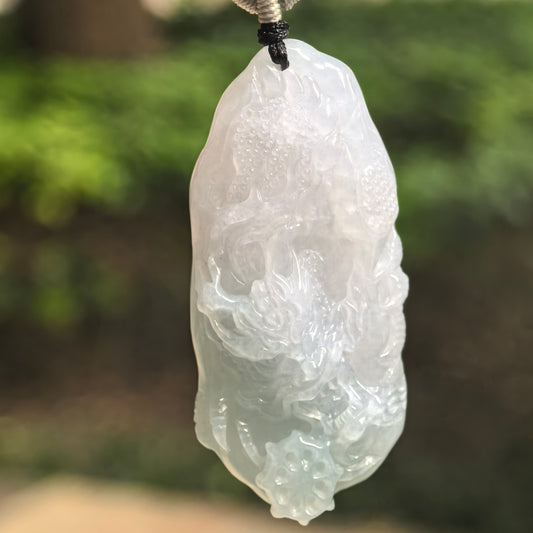 Natural Grade-A glutinous pale green jadeite dragon pendant hanging on cord.