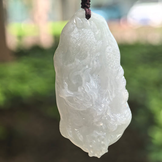 Natural Grade-A glutinous pale green jadeite dragon pendant hanging on cord.