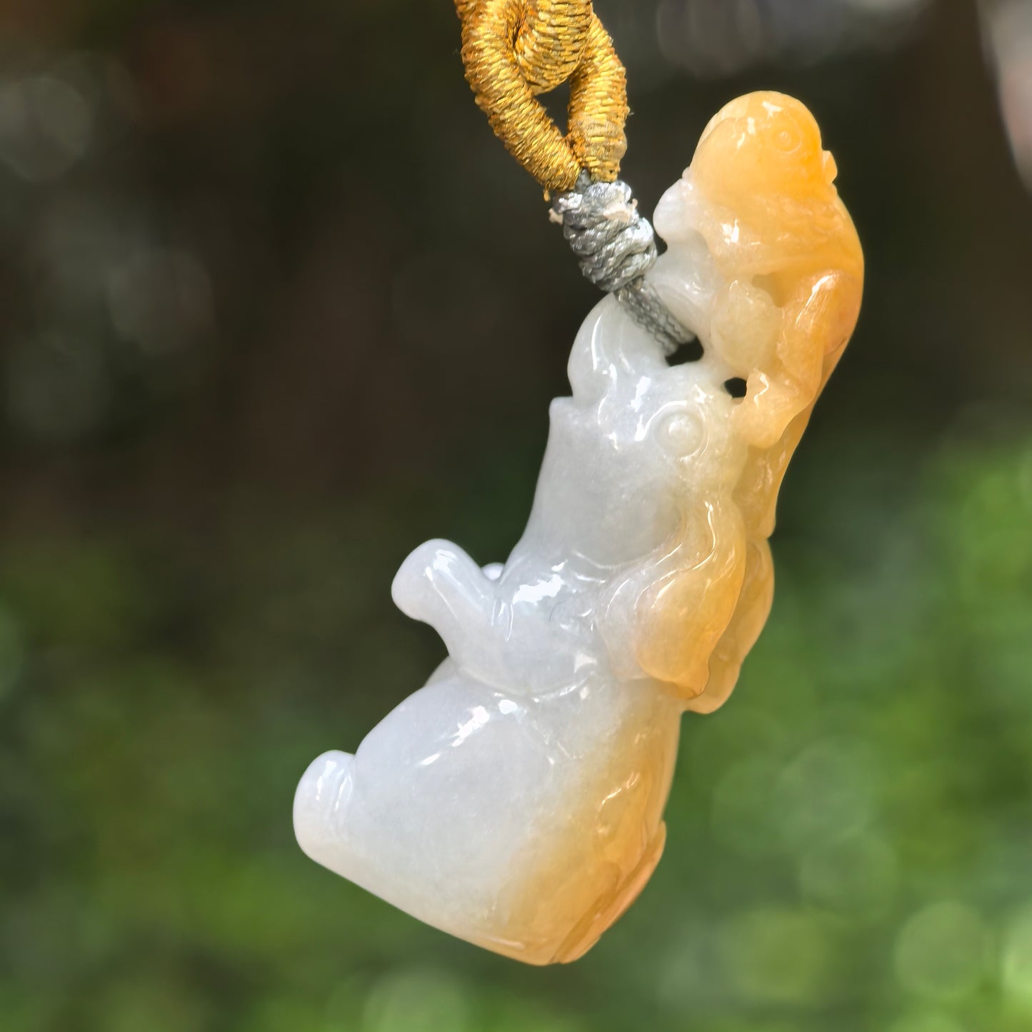 Natural Grade-A glutinous white and yellow skin jadeite monkey-on-elephant pendant hanging on cord.