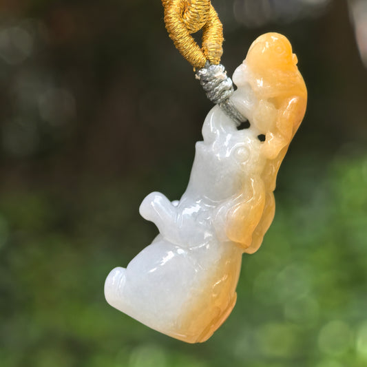 Natural Grade-A glutinous white and yellow skin jadeite monkey-on-elephant pendant hanging on cord.