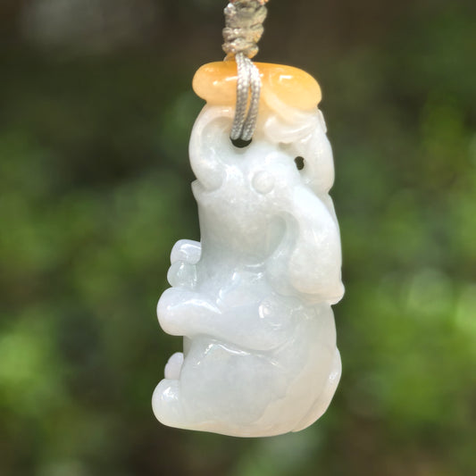 Natural Grade-A glutinous white and yellow jadeite elephant pendant hanging on cord.