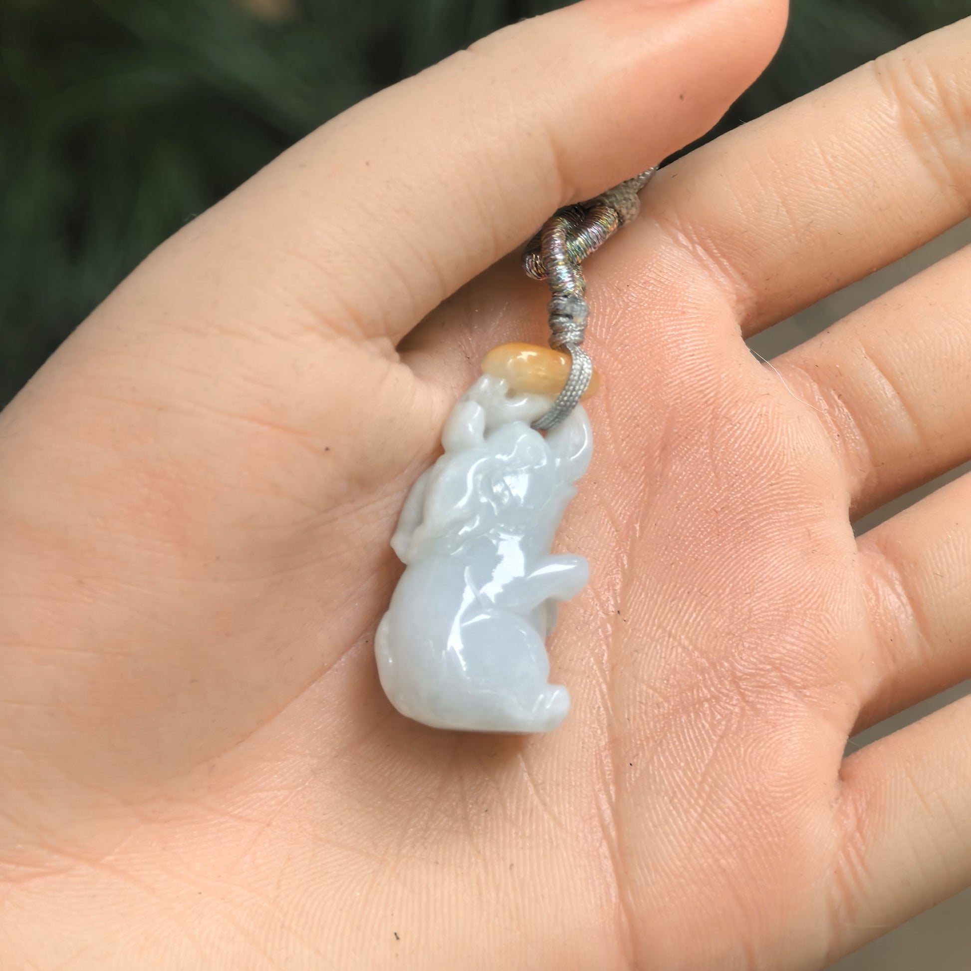 Small white jadeite elephant pendant with warm yellow accent near the top.