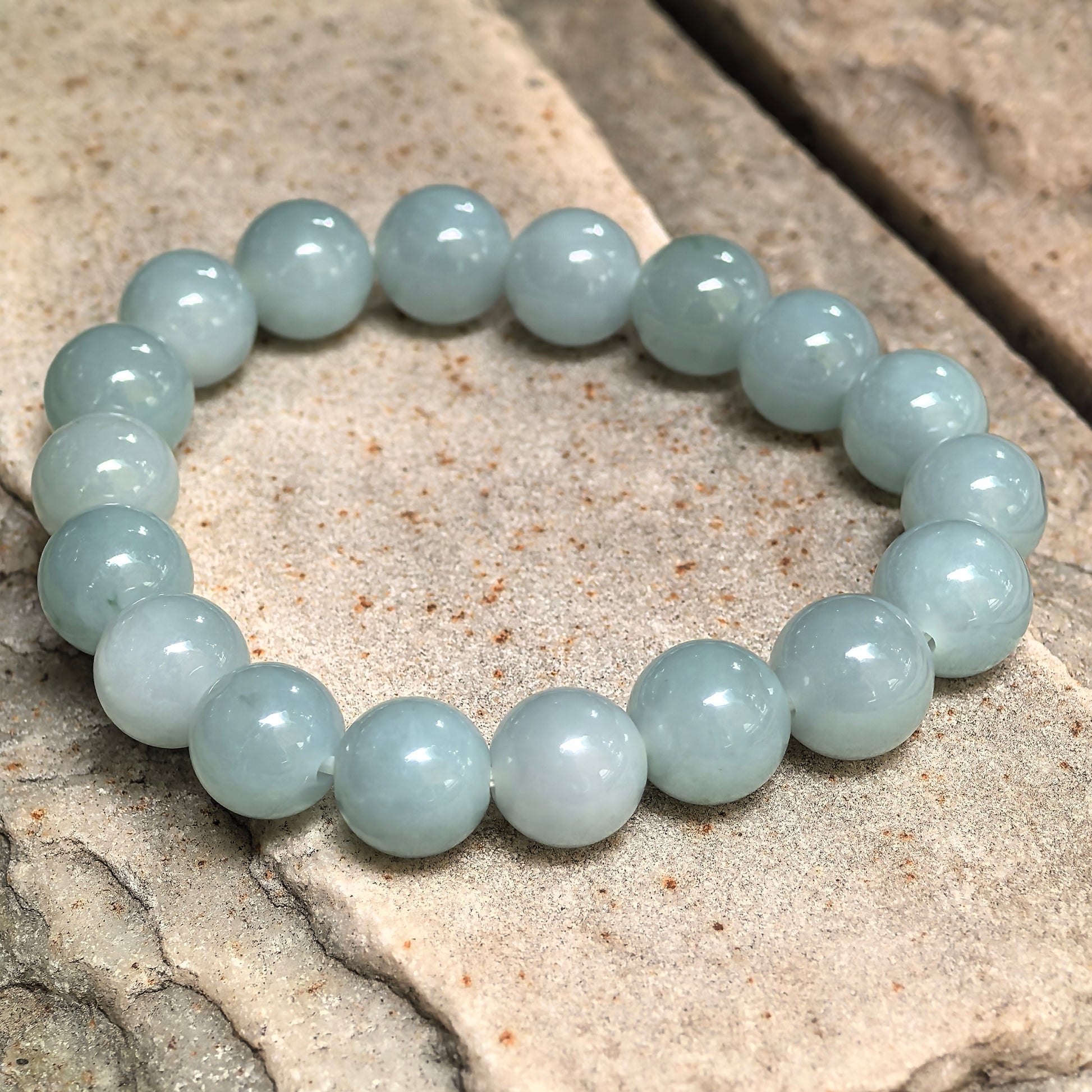Glutinous-icy jadeite bracelet with smooth round beads and refreshing green tone.