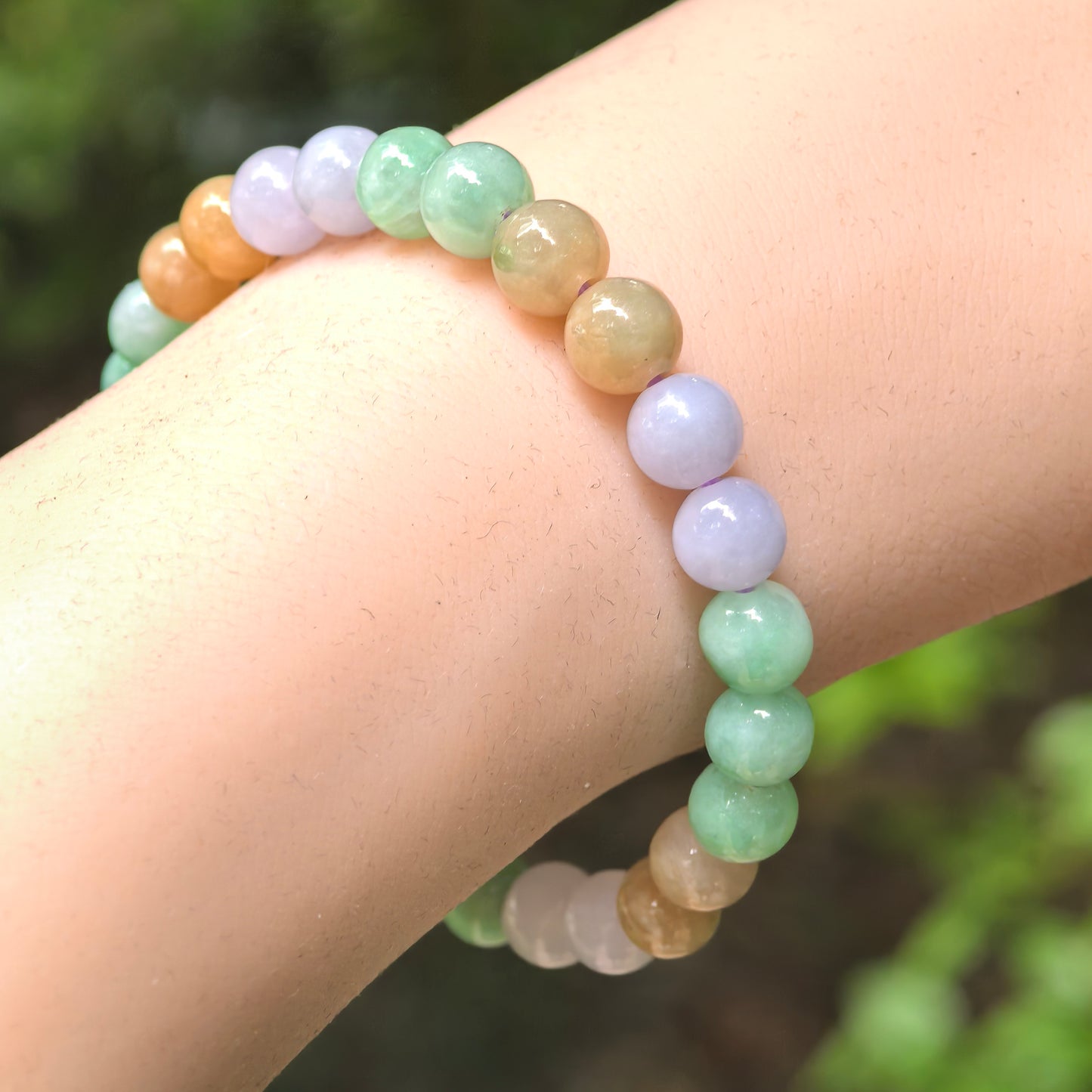 Natural Grade-A glutinous multicolor jadeite bead bracelet worn on the wrist.
