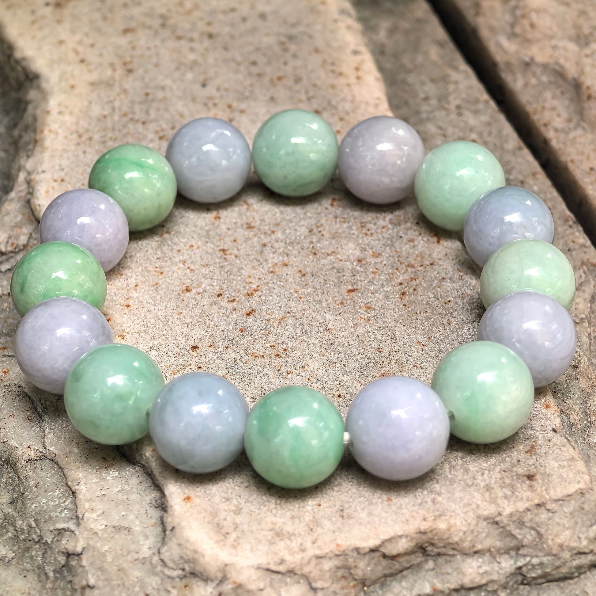 Glutinous purple green jadeite bead bracelet showing soft translucency and natural internal patterns.