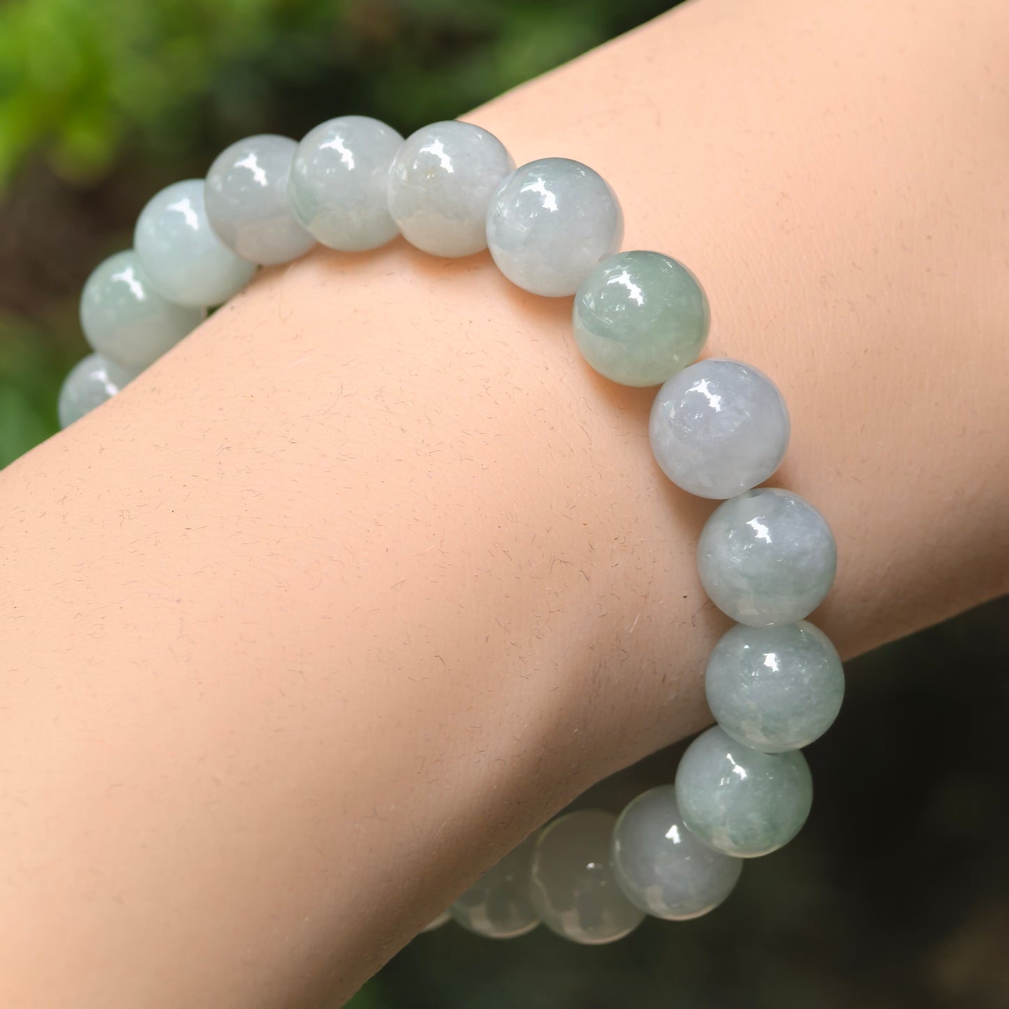 Natural Grade-A glutinous-icy pale green jadeite bead bracelet worn on the wrist.