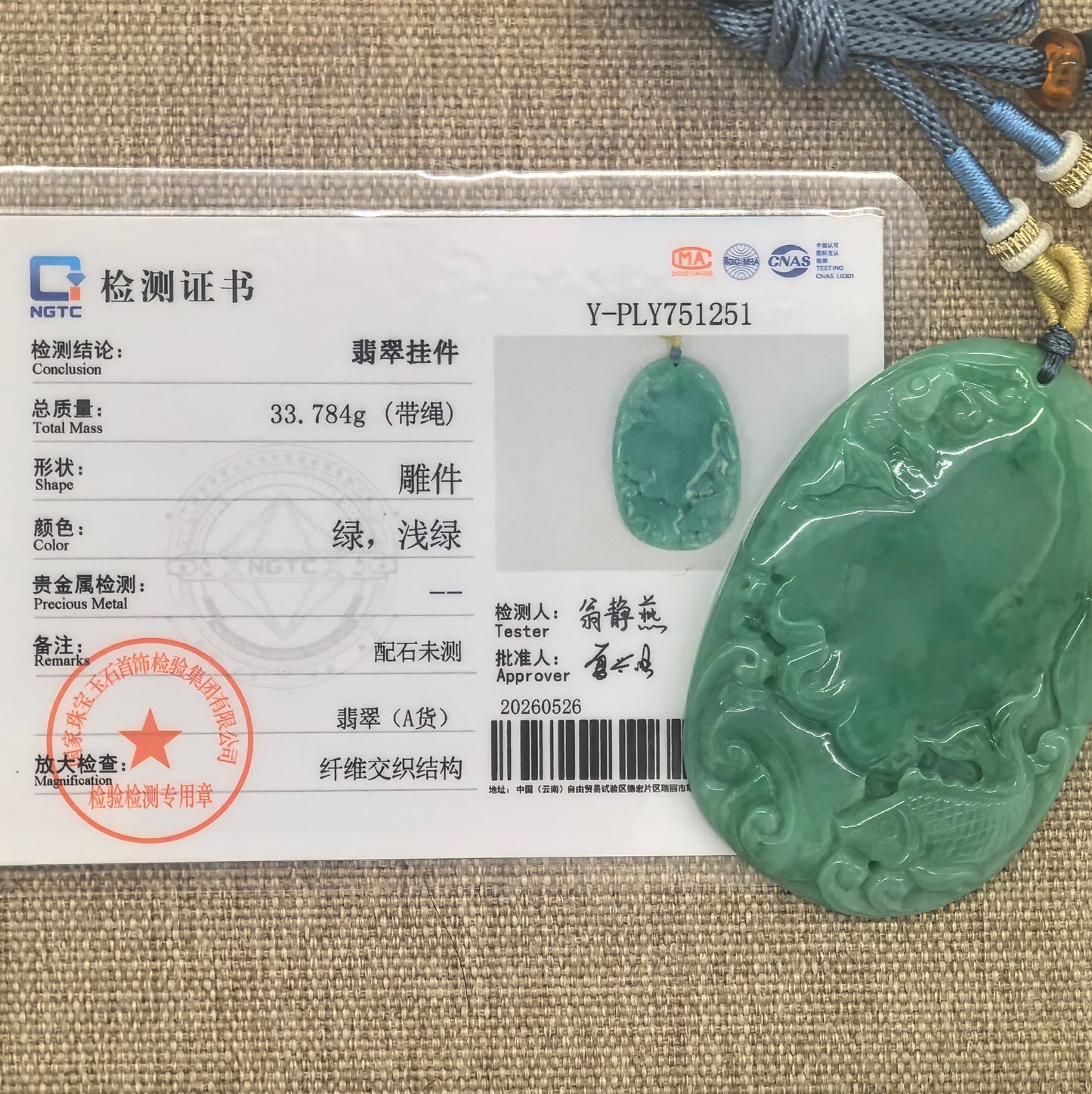 NGTC certified Natural Grade-A green jadeite fish plaque pendant shown with matching certificate and 33.784 g weight.
