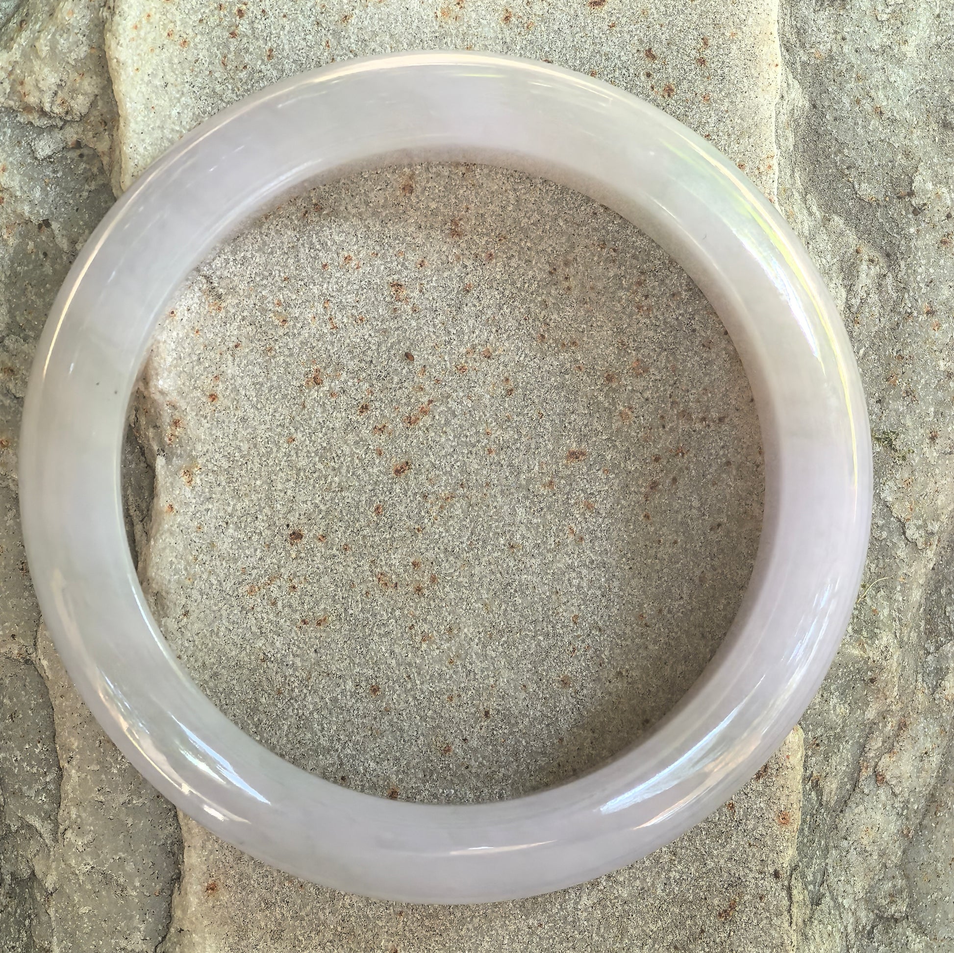 Top view of a pale purple jadeite bangle with a clean circular shape.
