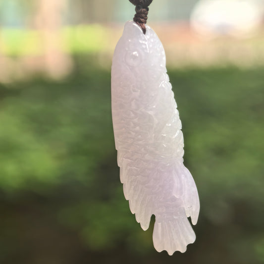 Natural Grade-A glutinous-icy light lavender fish jadeite pendant hanging in natural light.
