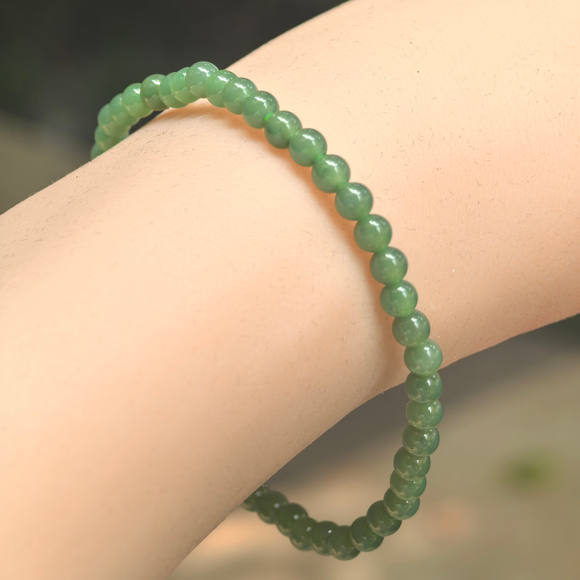 Natural Grade-A icy glutinous green jadeite beaded bracelet worn on the wrist.
