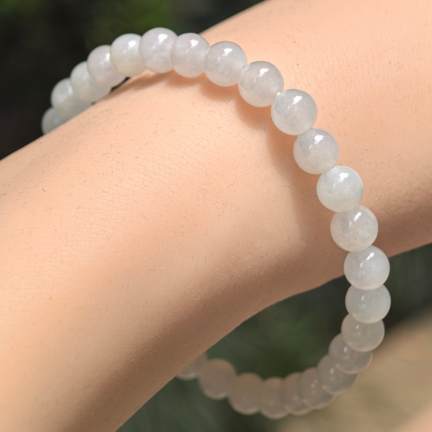 Natural Grade-A icy glutinous white jadeite beaded bracelet worn on the wrist.
