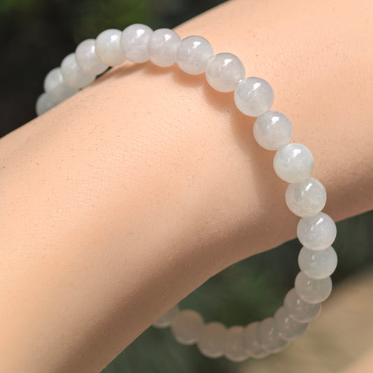 Natural Grade-A icy glutinous white jadeite beaded bracelet worn on the wrist.
