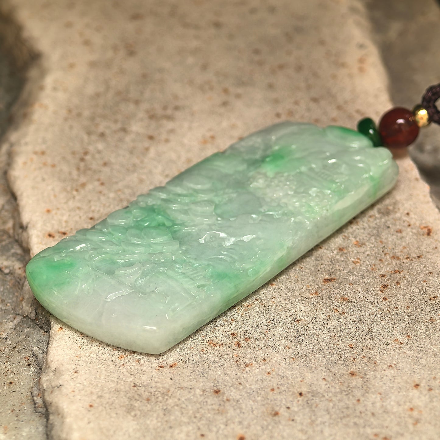 Carved green jadeite plaque pendant with smooth luster and vivid natural color.
