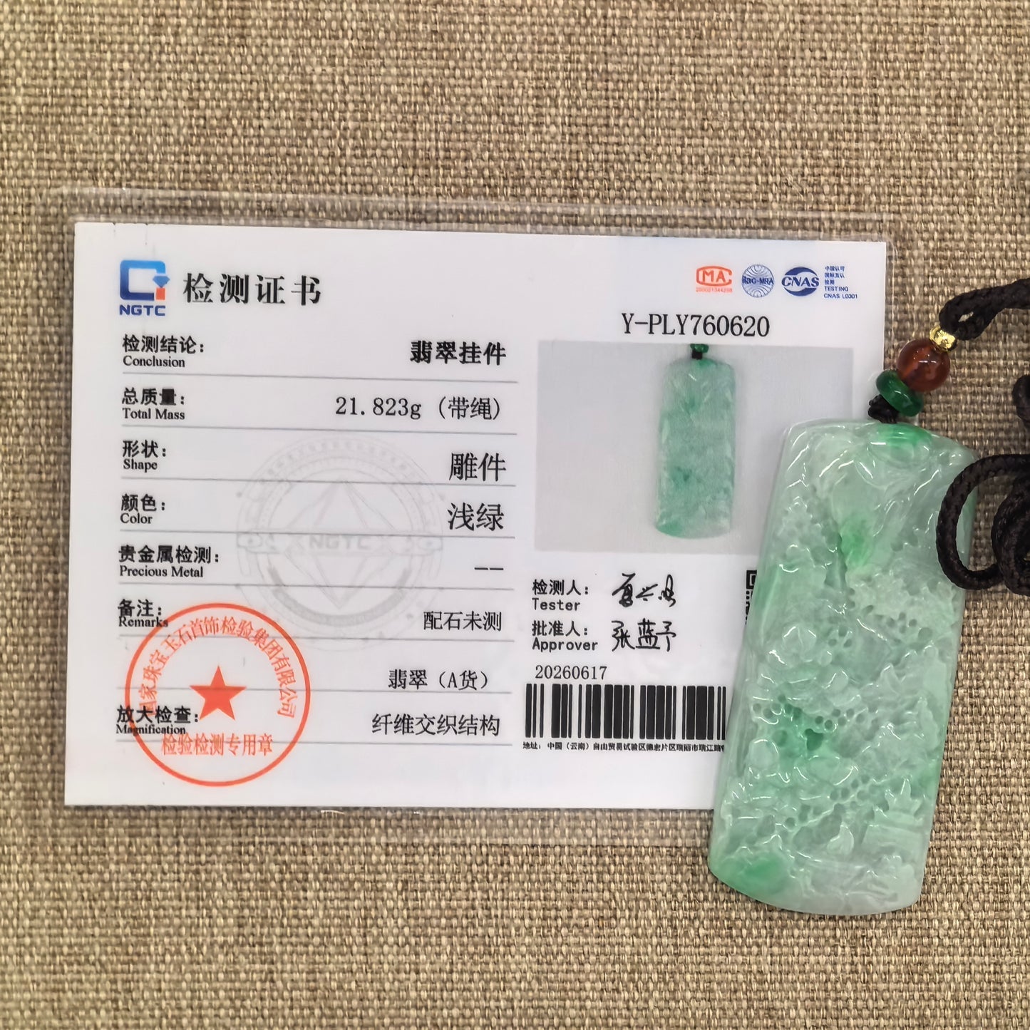 NGTC-certified natural Grade-A green landscape jadeite pendant displayed with matching certificate.