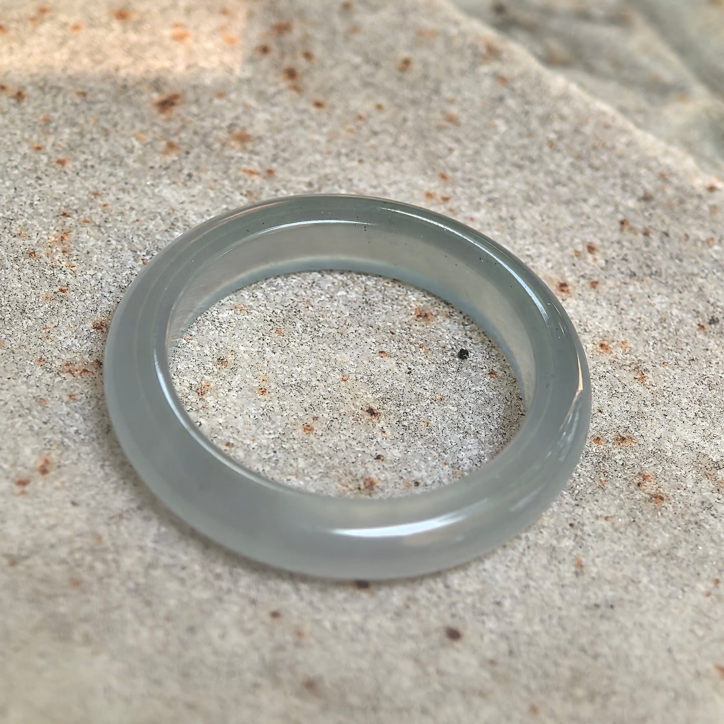 Detailed view of icy light green Burmese jadeite ring band with smooth polish and natural internal jadeite texture.
