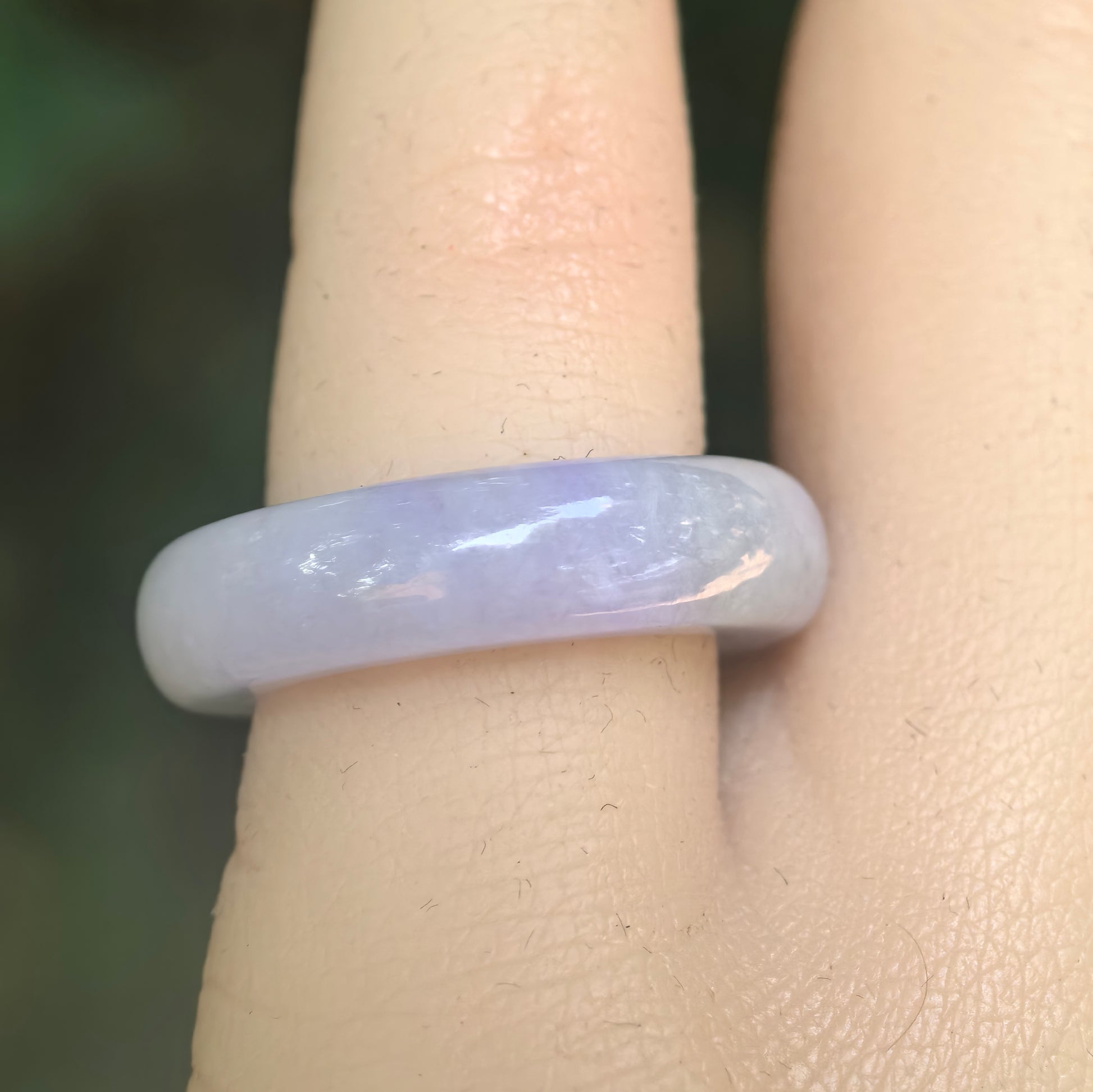 Close-up of lavender jadeite ring band showing soft purple color and smooth polished luster.
