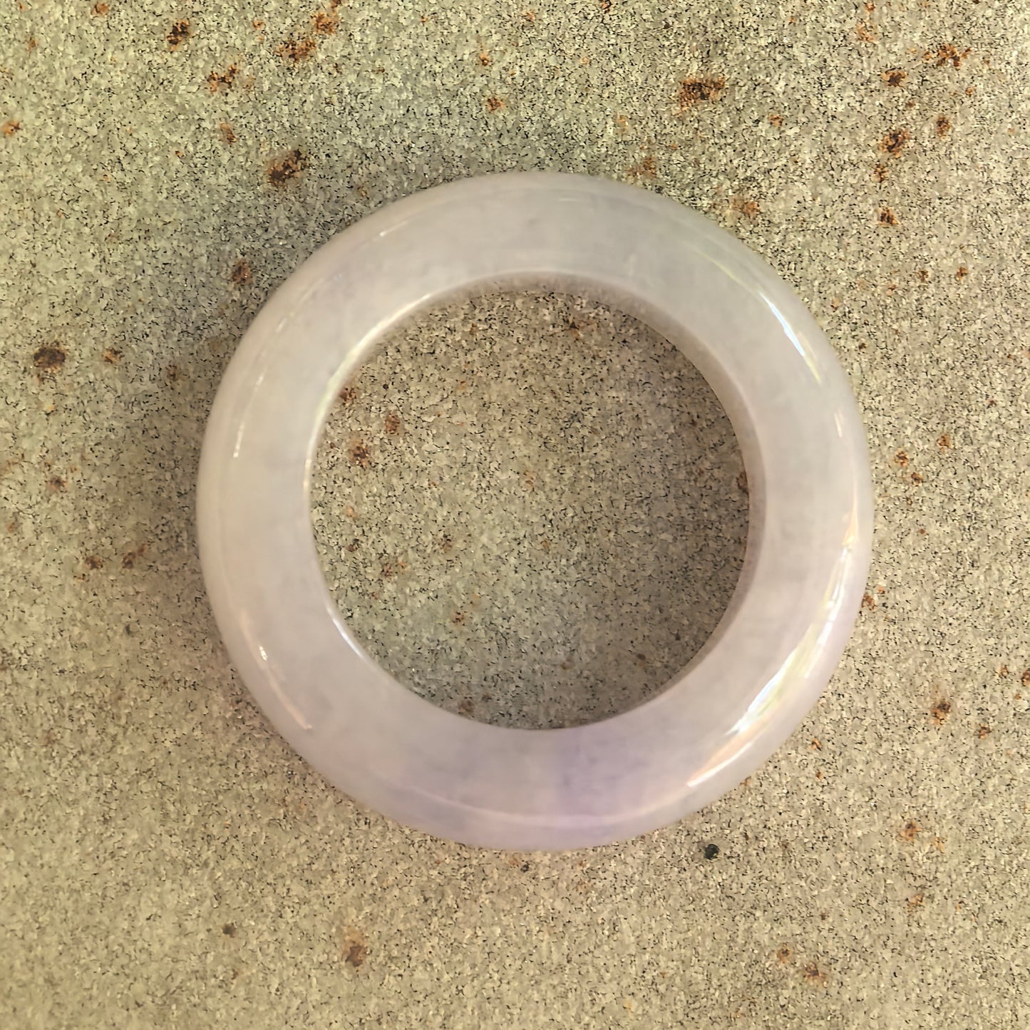 Top view of natural Grade-A lavender jadeite ring band showing rounded circular shape.
