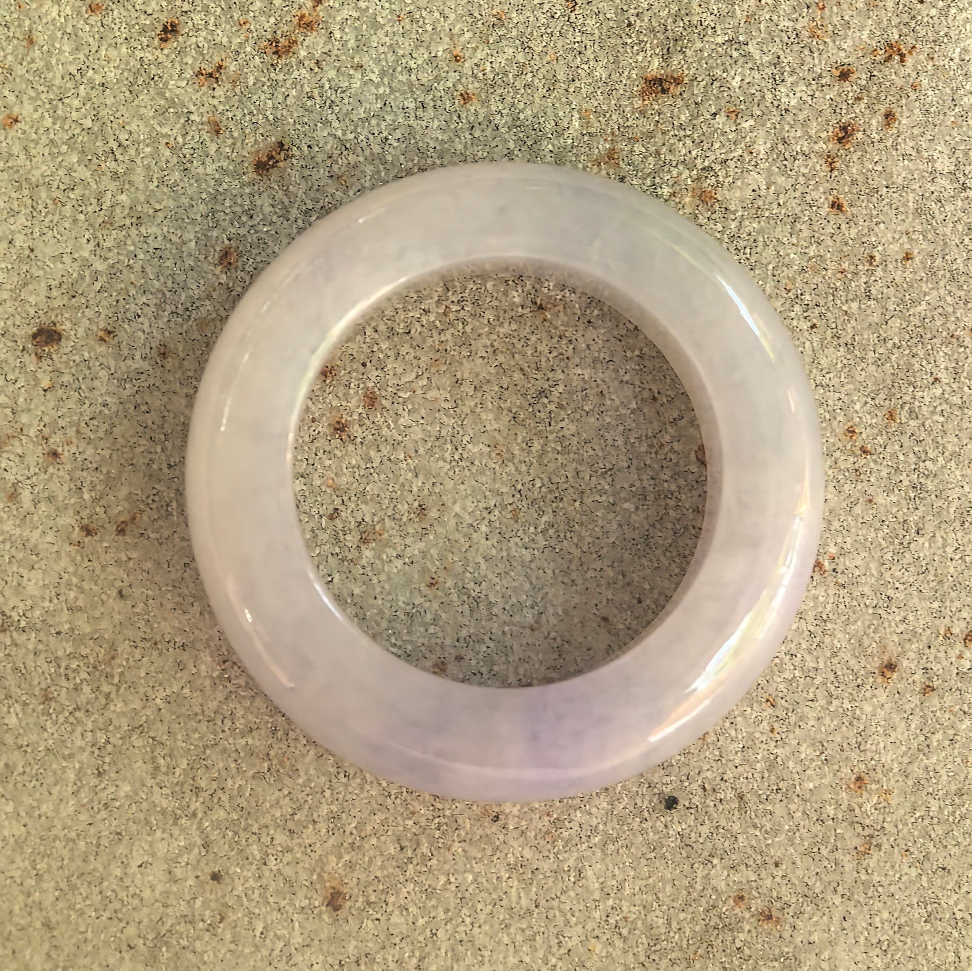 Top view of natural Grade-A lavender jadeite ring band showing rounded circular shape.
