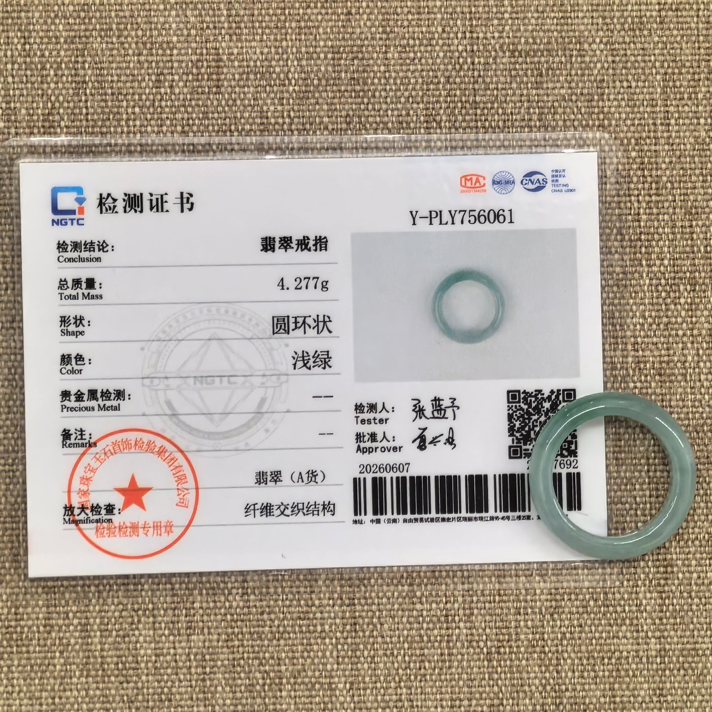 NGTC certified light green jadeite ring band shown with matching certificate, confirming natural Grade-A Burmese jadeite.