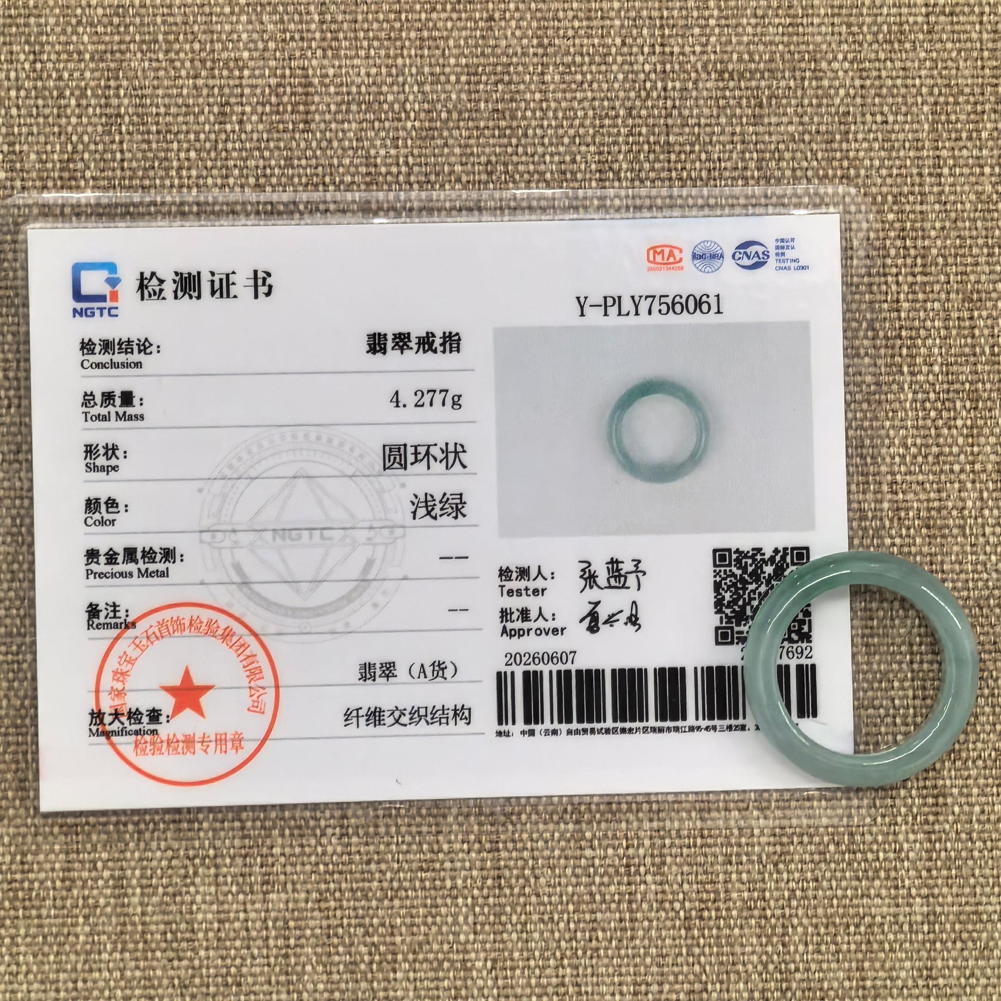 NGTC certified light green jadeite ring band shown with matching certificate, confirming natural Grade-A Burmese jadeite.