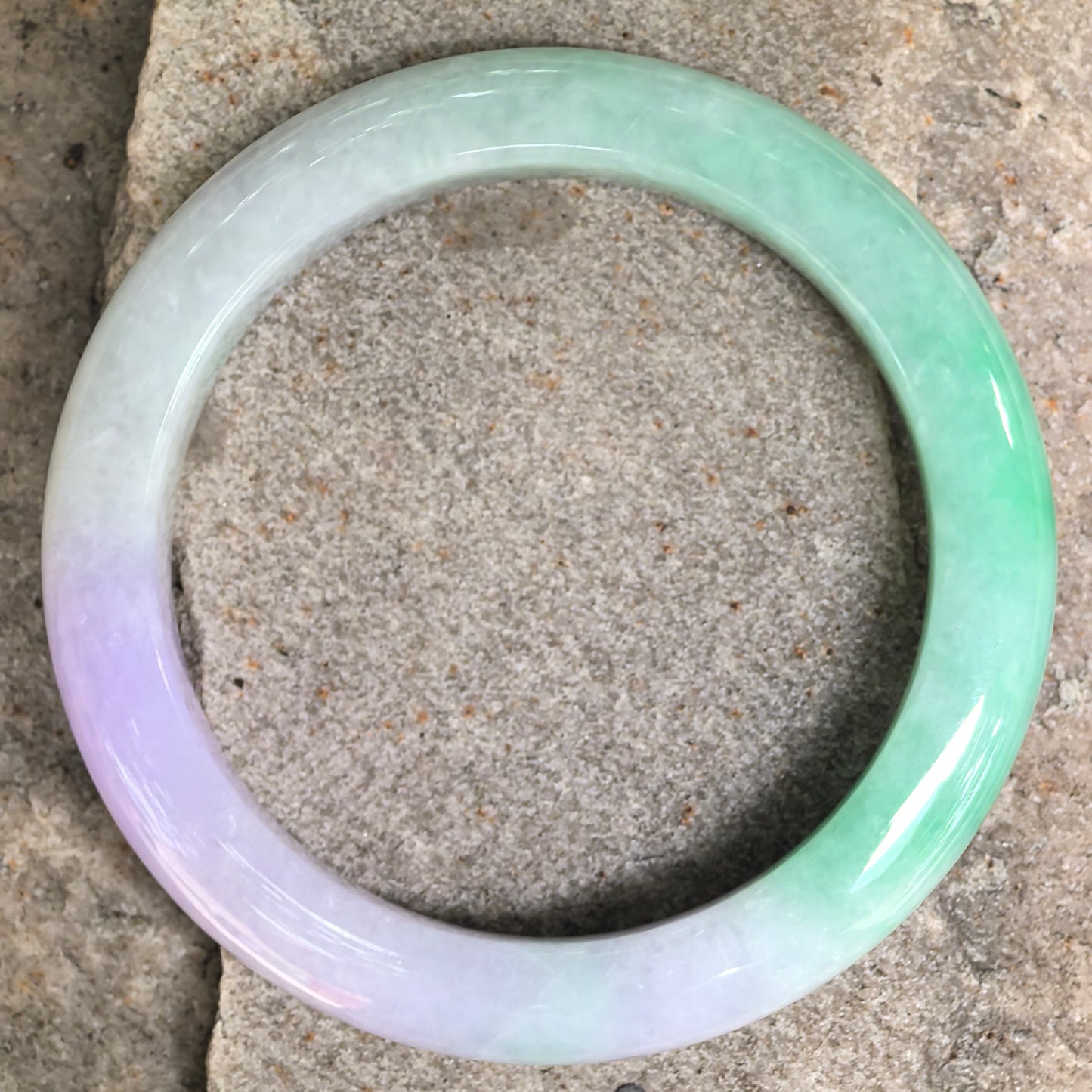 Top view of D-shape jadeite bangle showing full round form and natural jadeite texture.
