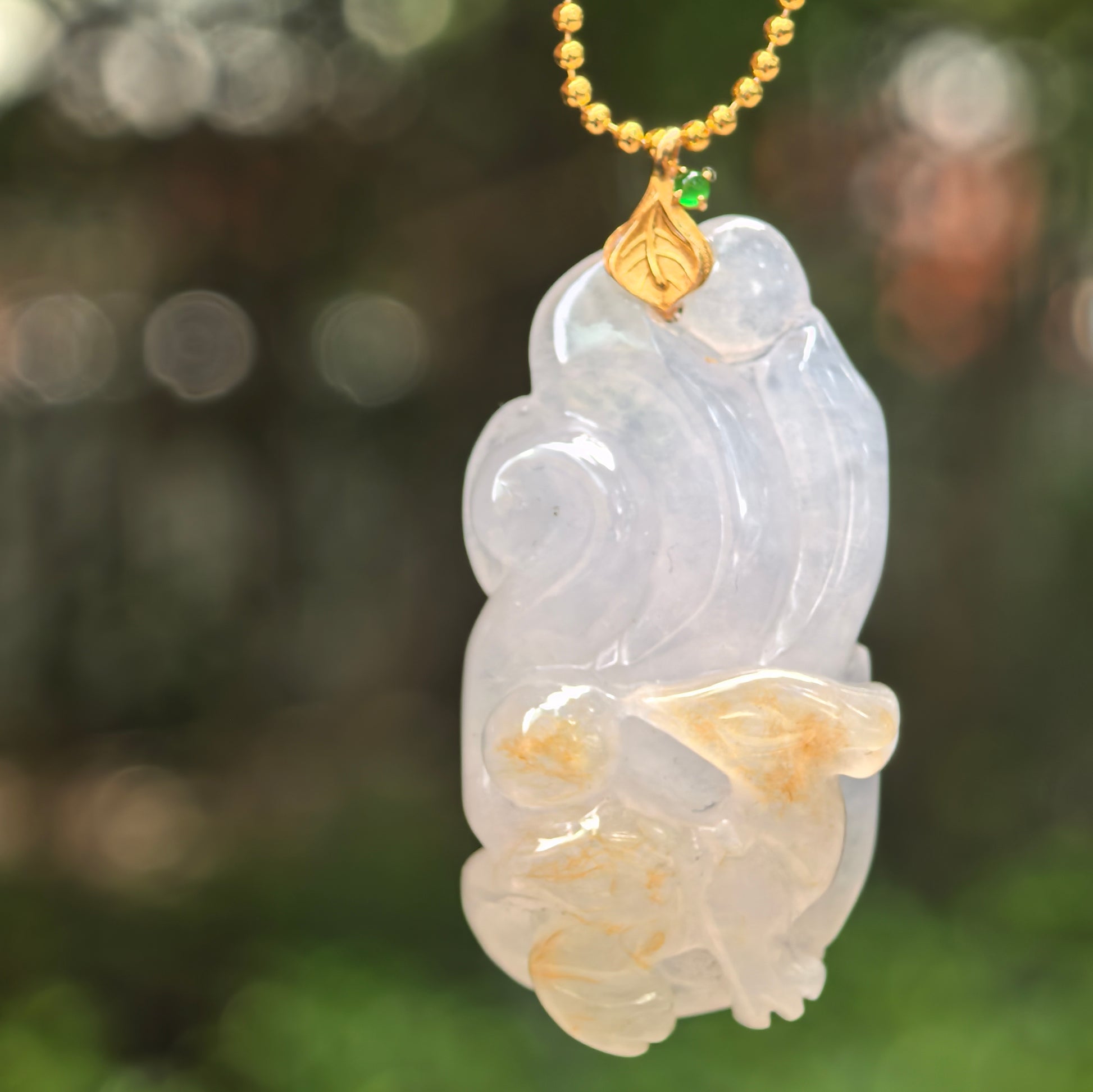 Natural Grade-A icy glutinous lavender-white nine-tailed fox jadeite pendant hanging in natural light.
