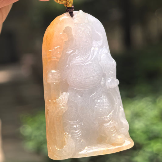 Natural Grade-A glutinous white and yellow Guan Gong jadeite pendant hanging in natural light.
