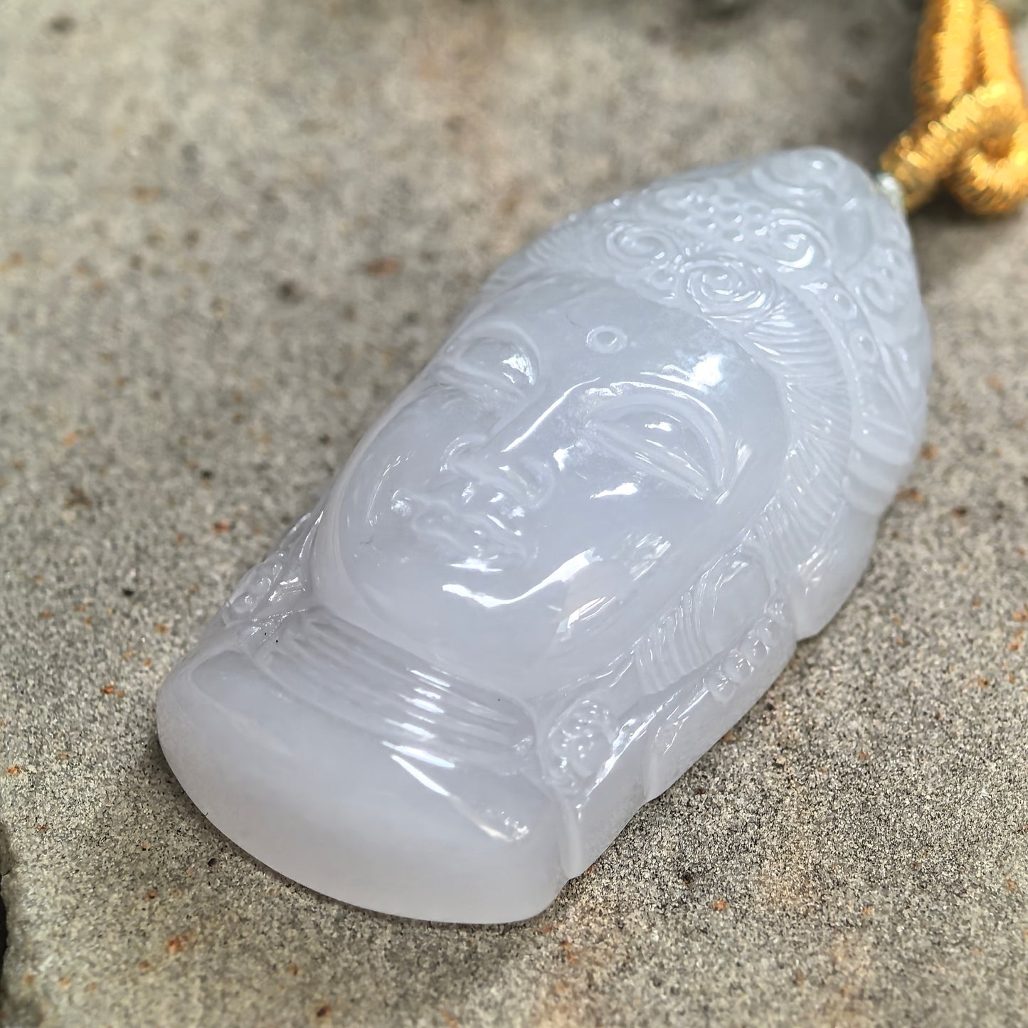 Natural untreated jadeite pendant with smooth luster and soft lavender-white color.
