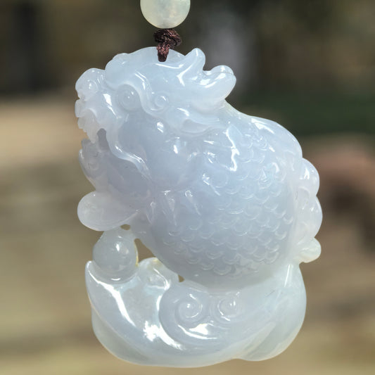 Natural Grade-A glutinous pale lavender dragon-fish jadeite pendant hanging in natural light.
