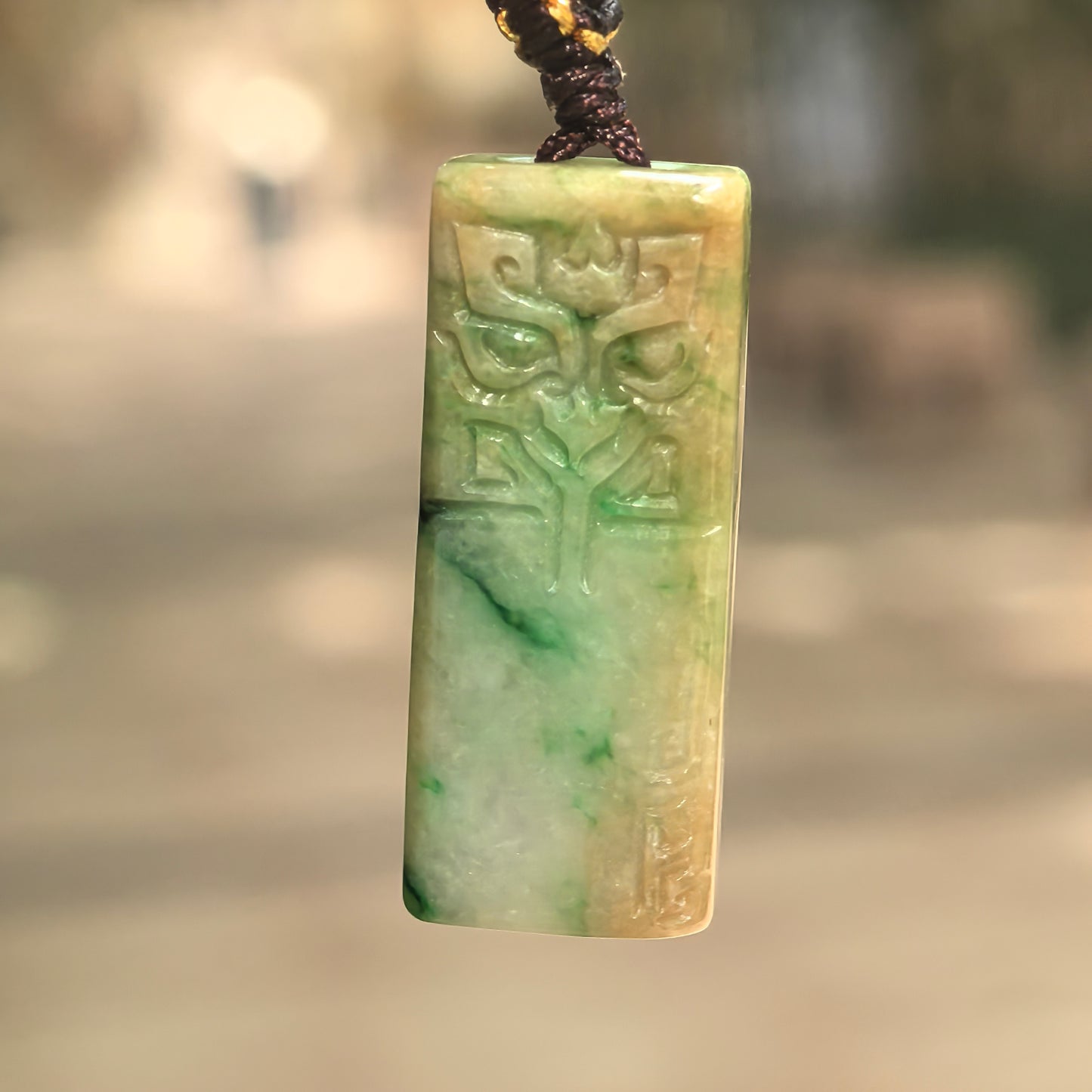 Natural Grade-A glutinous yellow-green plain plaque jadeite pendant hanging on cord.
