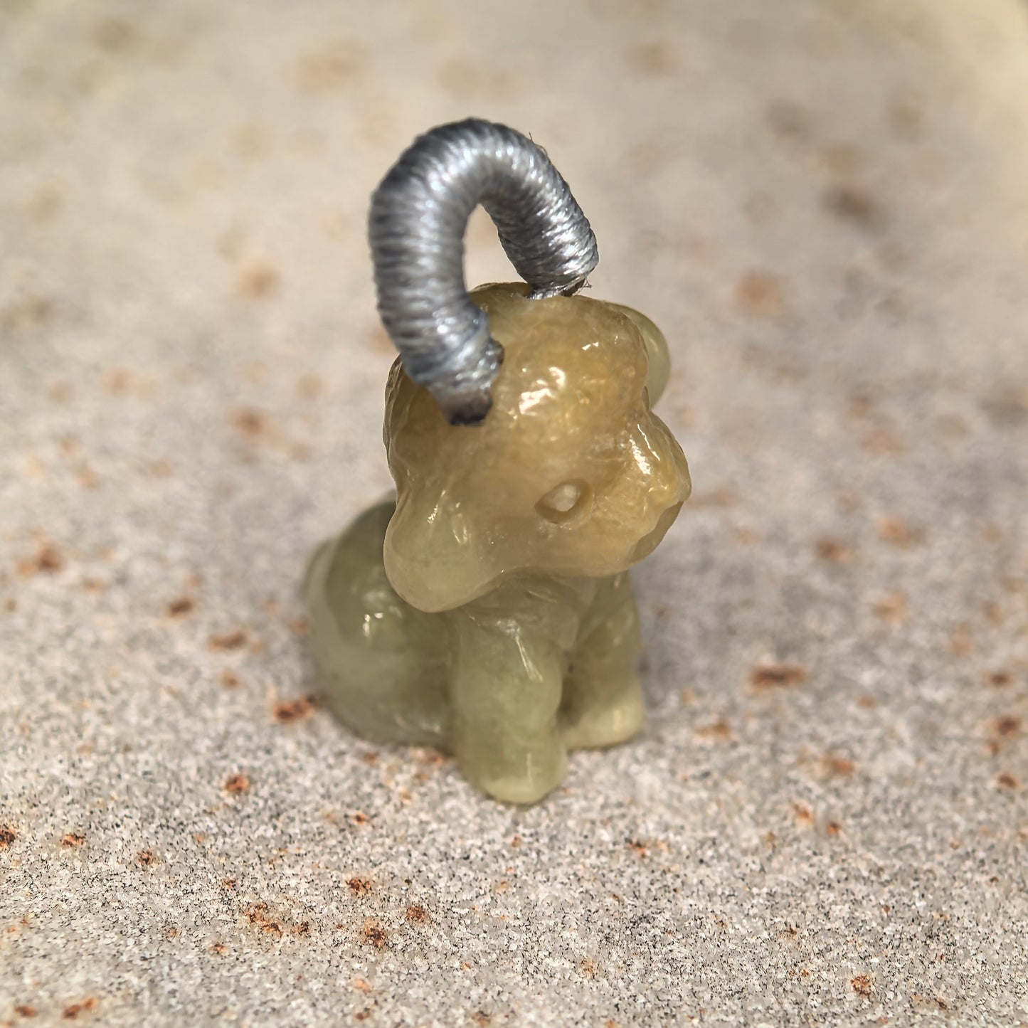 Three-dimensional carved dog jadeite charm with soft glutinous texture and cute expression.
