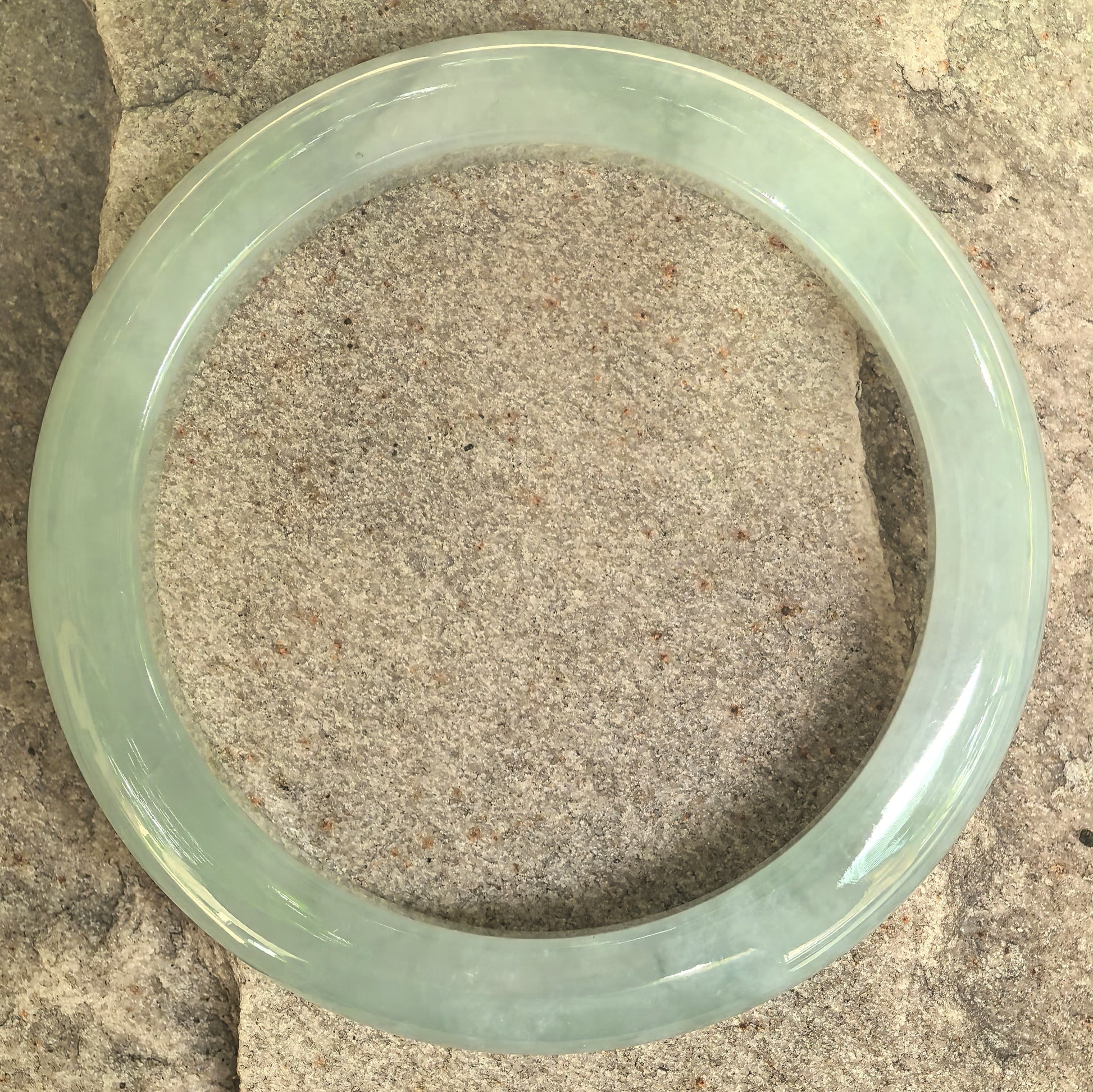 Top view of the natural Grade-A mint green D-shape jadeite bangle showing its even circular form.