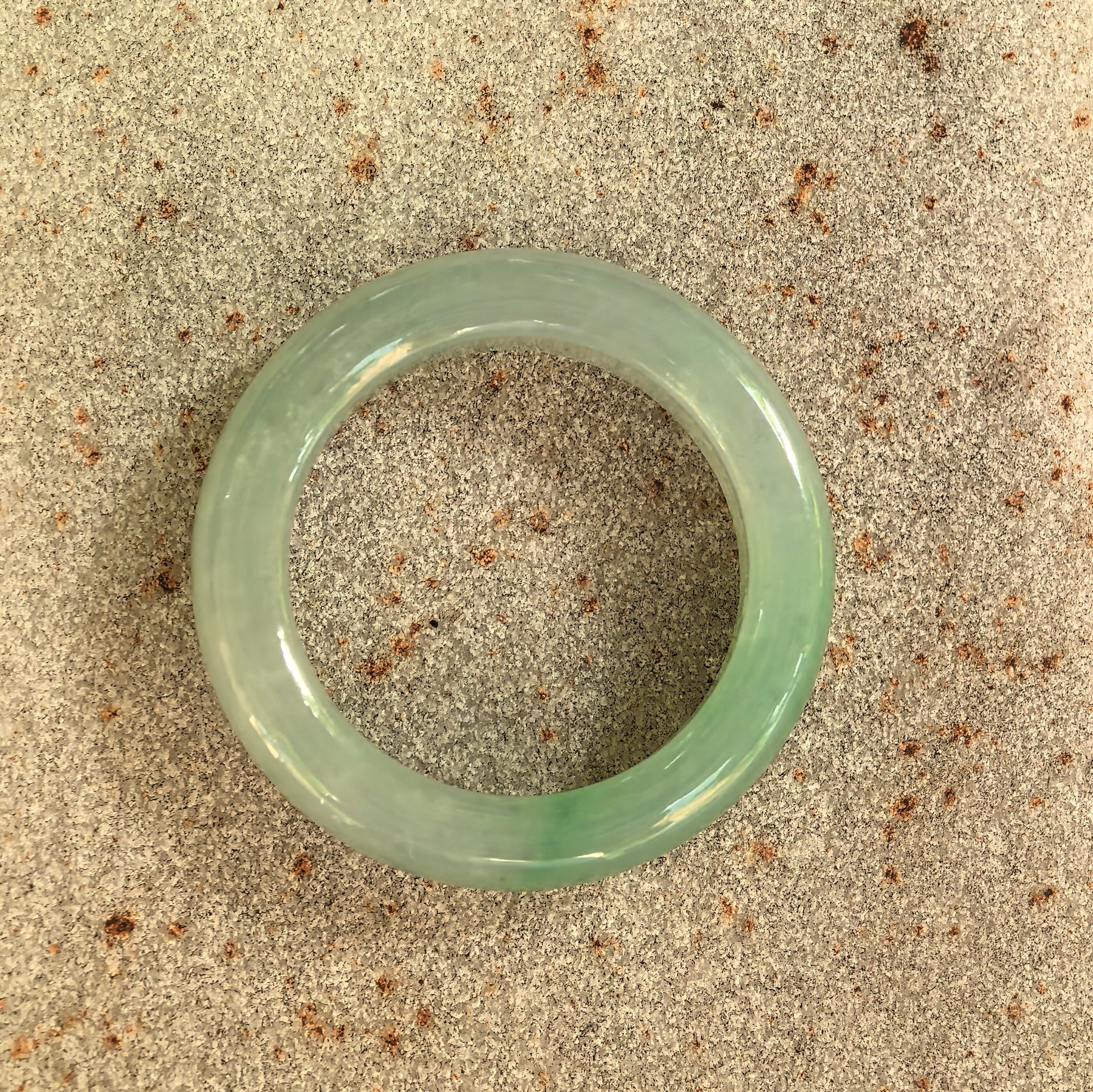 Top view of the natural Grade-A jadeite ring showing its circular shape and soft green color.